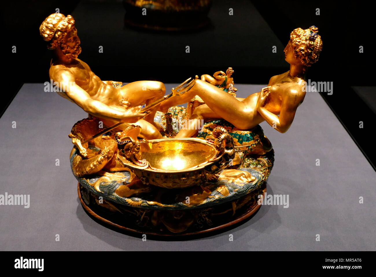 Photograph of the Cellini Salt Cellar (Saliera), a part-enamelled gold table sculpture, by Benvenuto Cellini. It was completed in 1543 for Francis I of France, from models that had been prepared many years earlier for Cardinal Ippolito d'Este. The Cellini Salt Cellar depicts a male figure representing the sea and a female figure that represents the earth. Benvenuto Cellini (1500-1571) an Italian goldsmith, sculptor, draftsman, solider, musician, and artist. Dated 16th Century Stock Photo