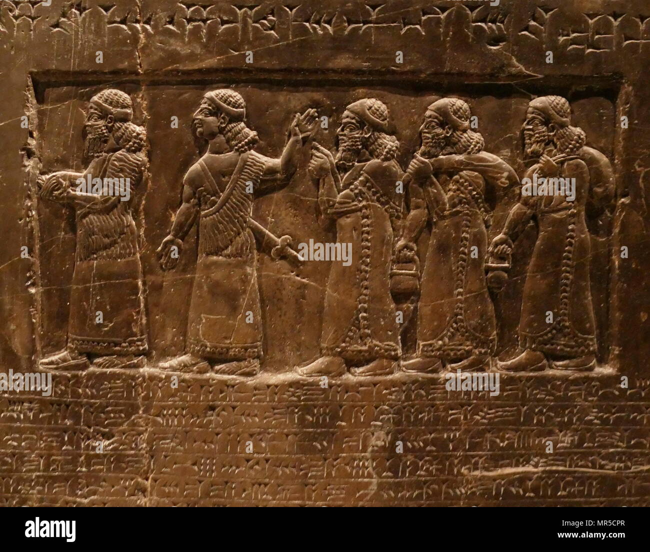 Detail from the Black Obelisk, of Shalmaneser III. A black limestone Assyrian sculpture with scenes in bas-relief and inscriptions. It comes from Nimrud (ancient Kalhu), in northern Iraq, and commemorates the deeds of King Shalmaneser III (reigned 858-824 BC). Stock Photo