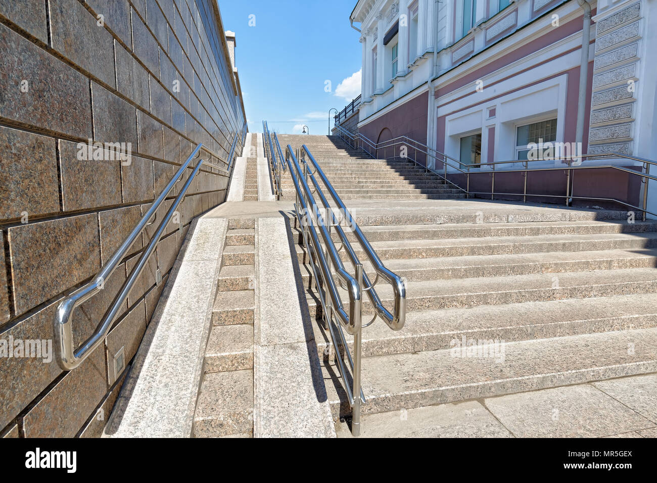Omsk, Russia. A large steep ramp for wheelchairs as part of a staircase in the central part of the city Stock Photo