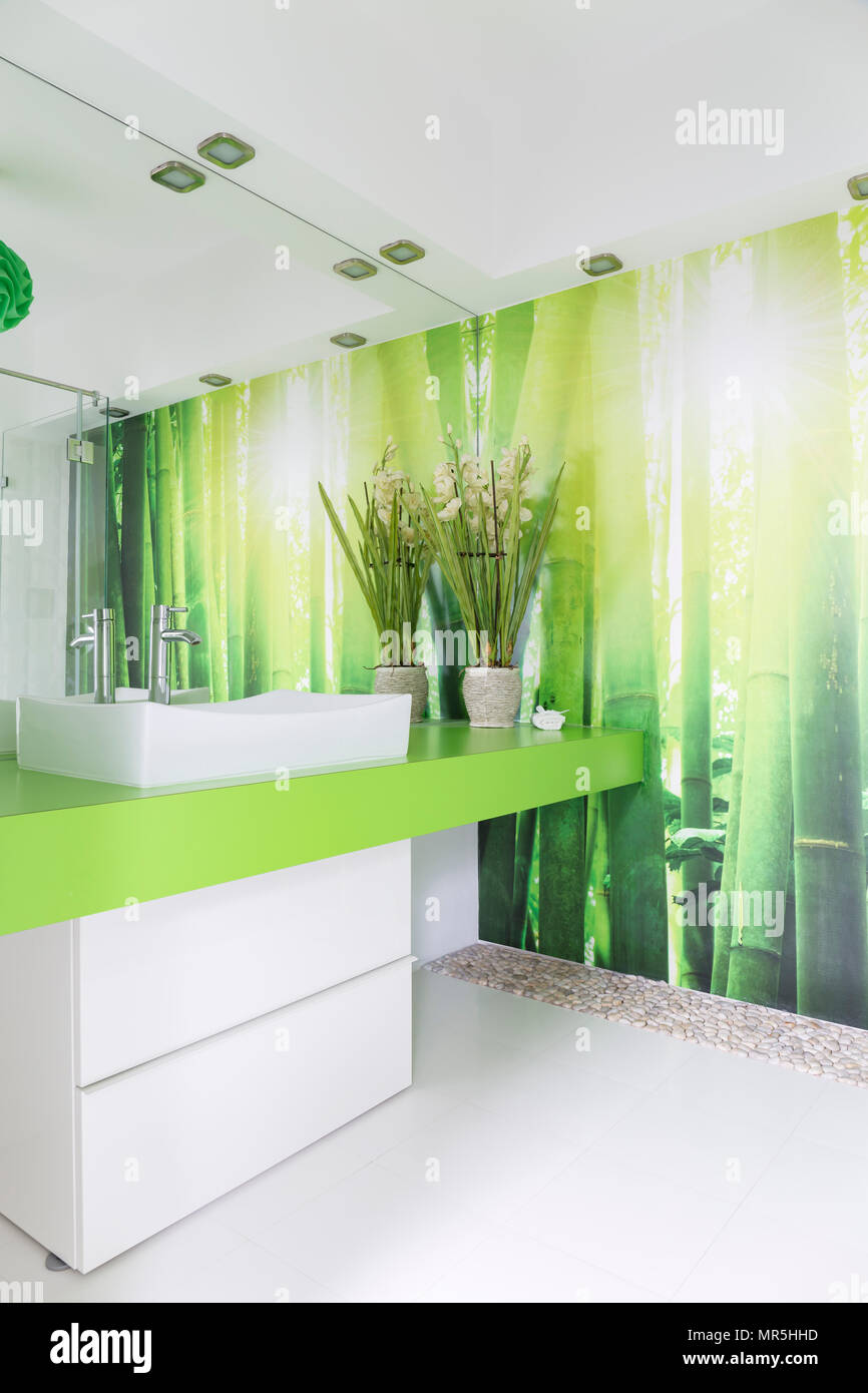 White and green bathroom with countertop basin and bamboo wallpaper ...