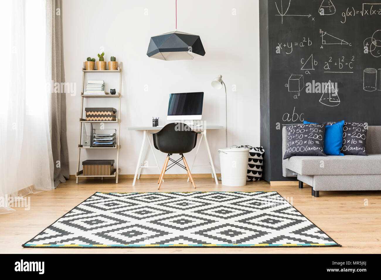 Shot of an elegant student room with a big blackboard and minimalist