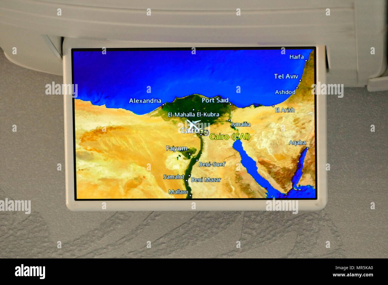 Overhead TV screen monitor on a 777 Airliner showing the flight path of an aircraft in Northern Egypt Stock Photo