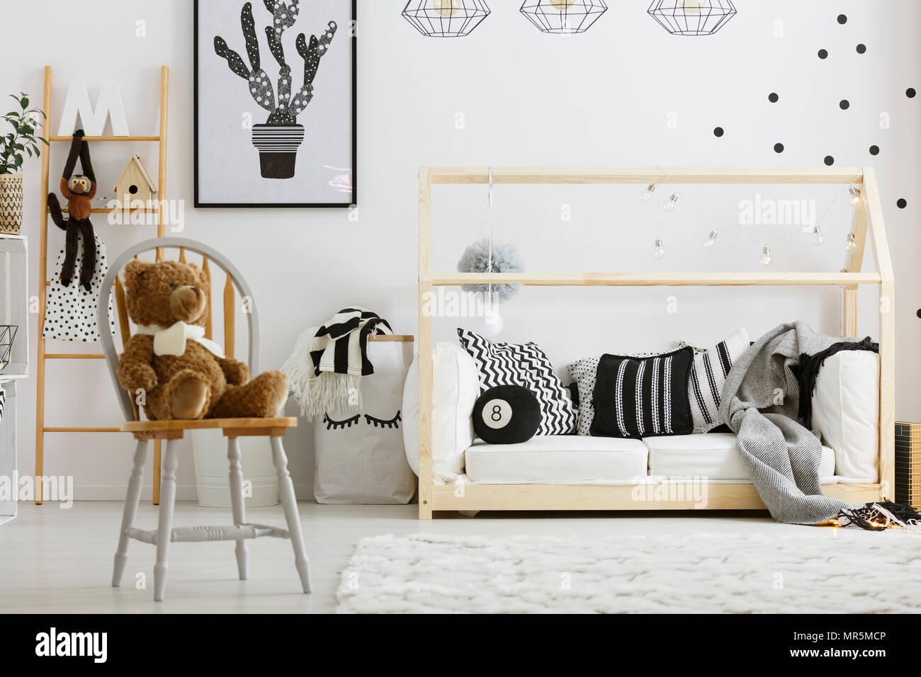 Black and white boy bedroom with house bed and chair Stock Photo - Alamy, image size:1300x956
