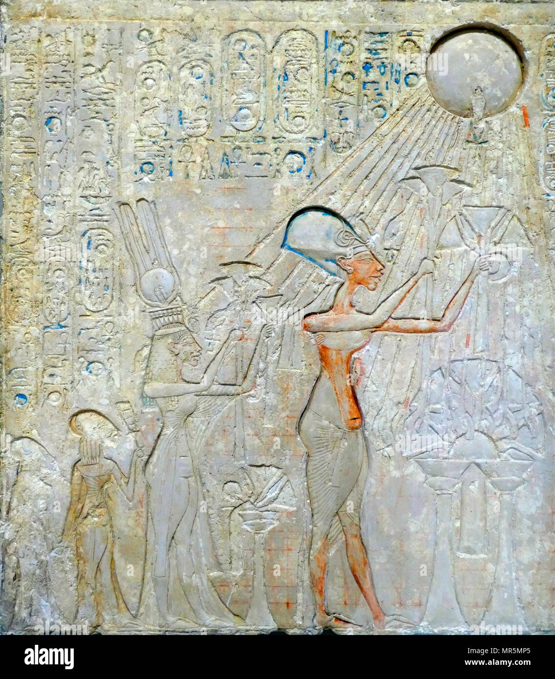 stele representing Akhenaton, Nefertiti and daughters worshiping the Aten sun disk. King Akhenaten, ruled Egypt for about 17 years: He changed the state cult of Amun Ra to that of Aten, and moved the capital from Thebes to Tell el-Amarna. Stock Photo