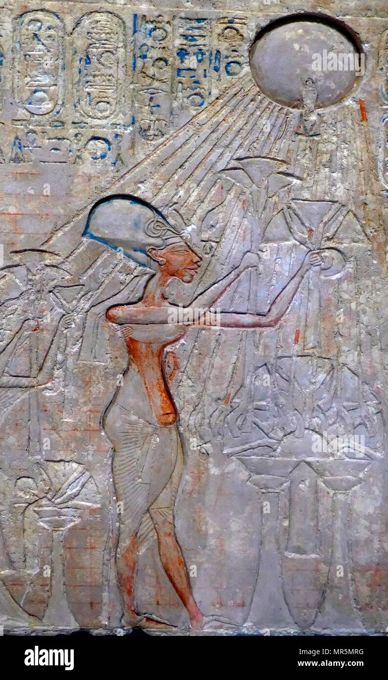 stele representing Akhenaton, worshiping the Aten sun disk. King Akhenaten, ruled Egypt for about 17 years: He changed the state cult of Amun. Ra to that of Aten, and moved the capital from Thebes to Tell el-Amarna. Stock Photo