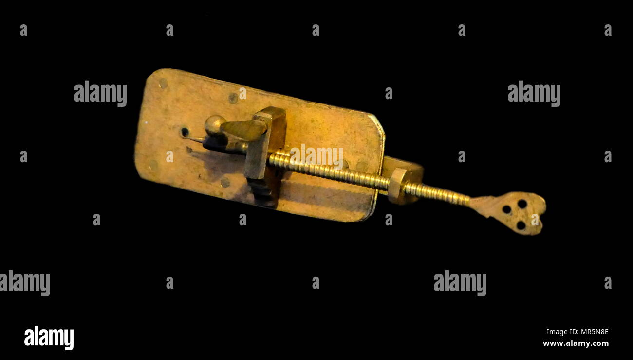 Replica of the first Microscope by Leeuwenhoek. Antonie van Leeuwenhoek who achieved up to 300 times magnification using a simple single lens microscope. He sandwiched a very small glass ball lens between the holes in two metal plates riveted together, and with an adjustable-by-screws needle attached to mount the specimen. Van Leeuwenhoek re-discovered red blood cells and spermatozoa, and helped popularise the use of microscopes to view biological ultrastructure. 1676, Stock Photo