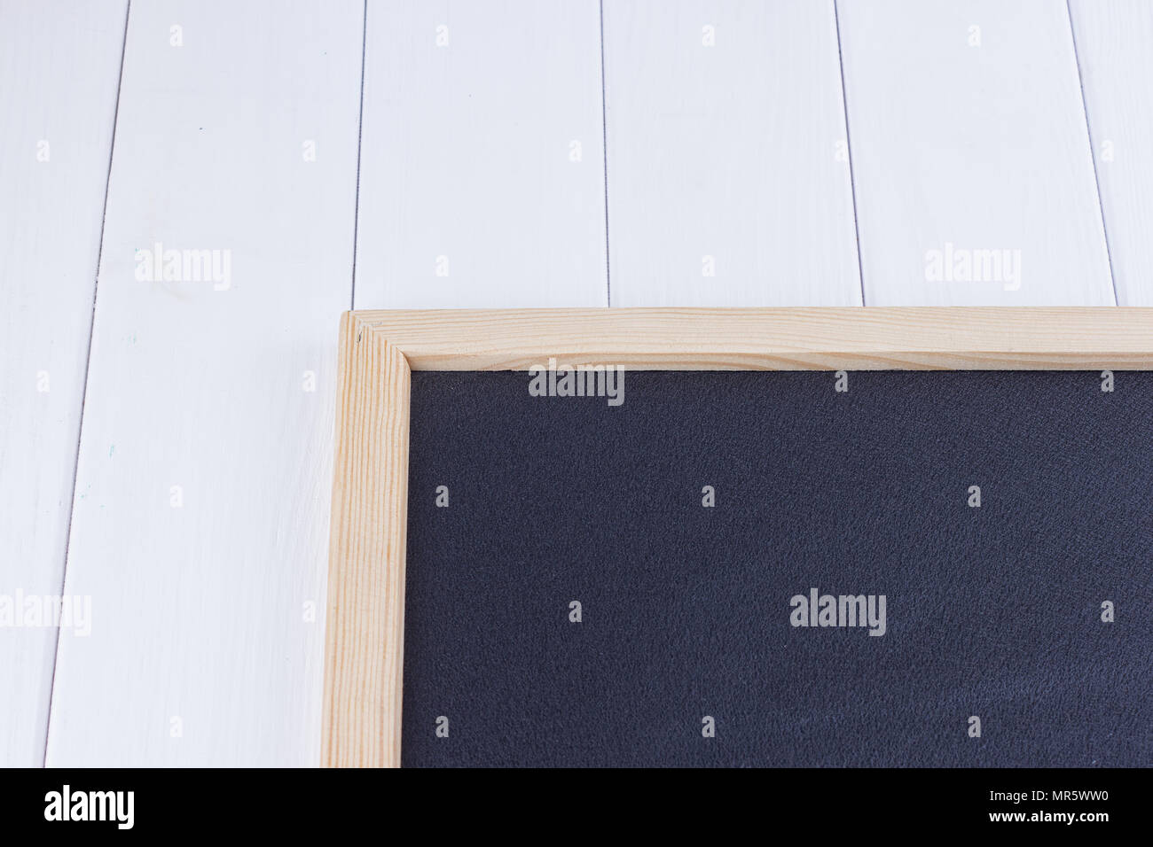 Old blank vintage school slate or chalkboard lying on an old rustic