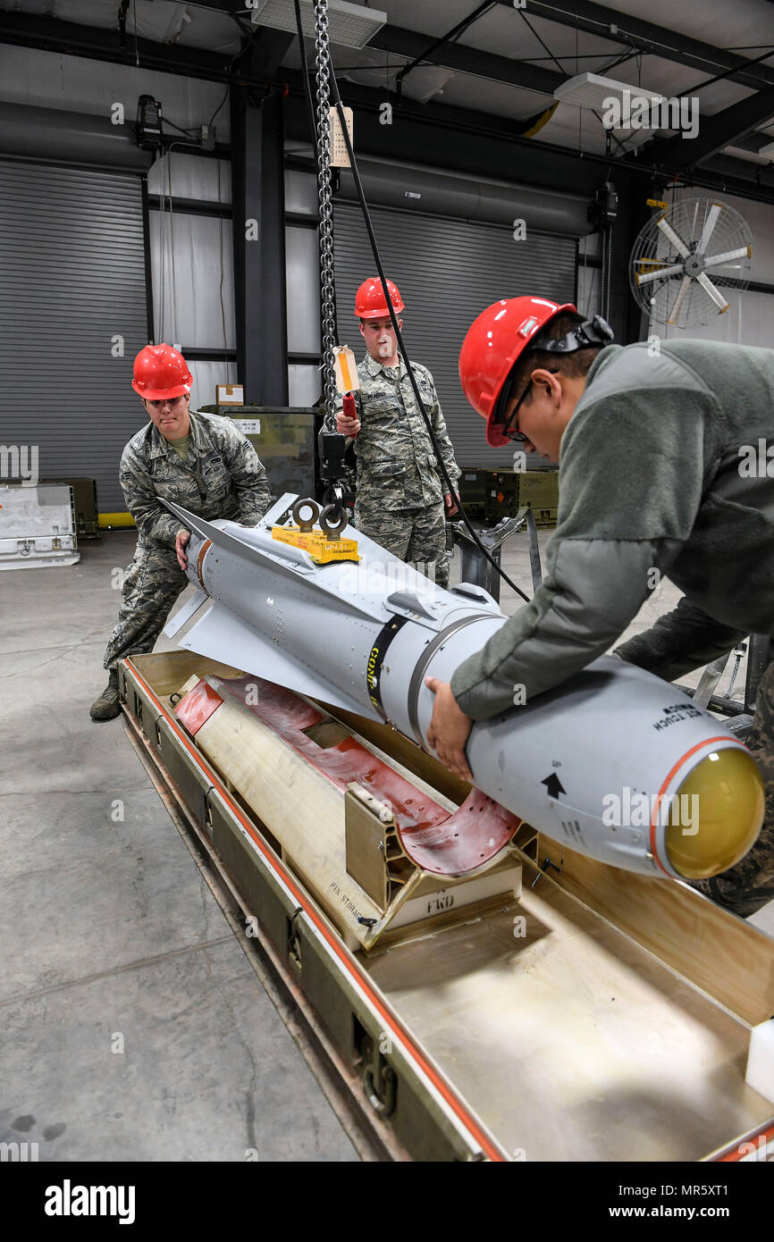 Airmen from 23rd Equipment Maintenance Squadron, Moody Air Force Base, Georgia, load an AGM-65 Maverick air-to-surface guided missile into a shipping container after it passed a tracking function test April 26 at Hill Air Force Base, Utah. Pictured from the left are Senior Airman Lauren Smith, Senior Airman Troy Praisner and Senior Airman Kyle Rodriguez. The Airmen participated in Combat Hammer, which is conducted by the 86th Fighter Weapons Squadron. It is an air-to-ground weapons evaluation exercise which collects and analyzes data on the performance of precision weapons and measures their s Stock Photo