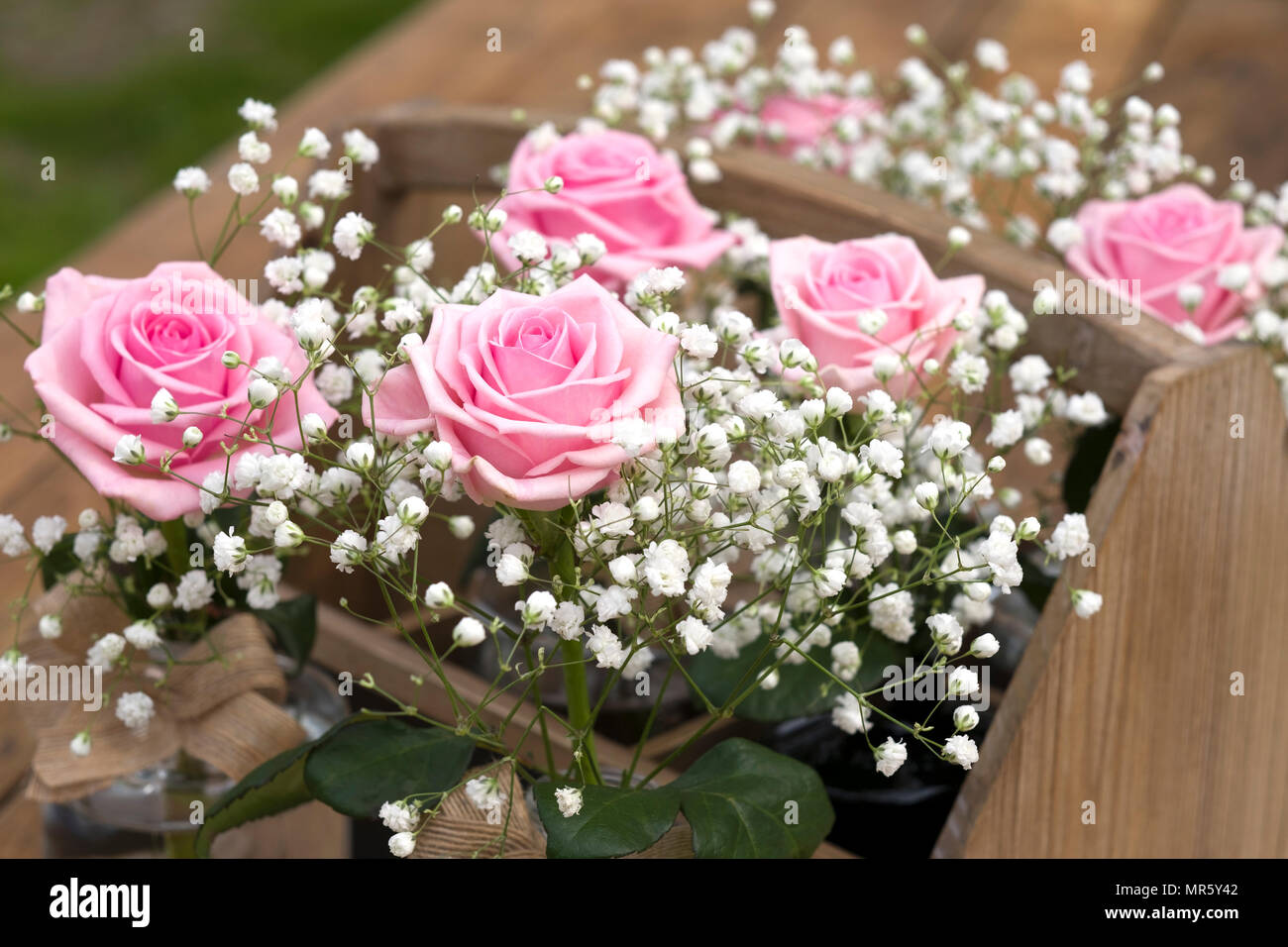 Simple Arrangements Of Pink Roses And White Gypsophilia Prepared