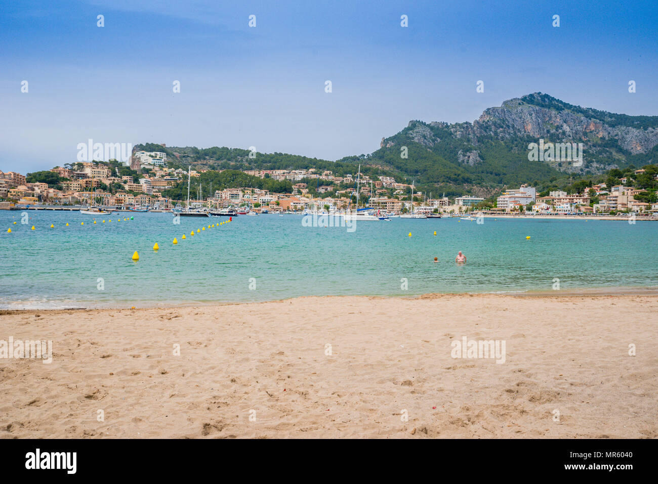 Puerto de Soller, Port of Mallorca island in balearic islands, Spain. Beautiful  beach and bay with boats in clear blue water of summer day. Stock Photo