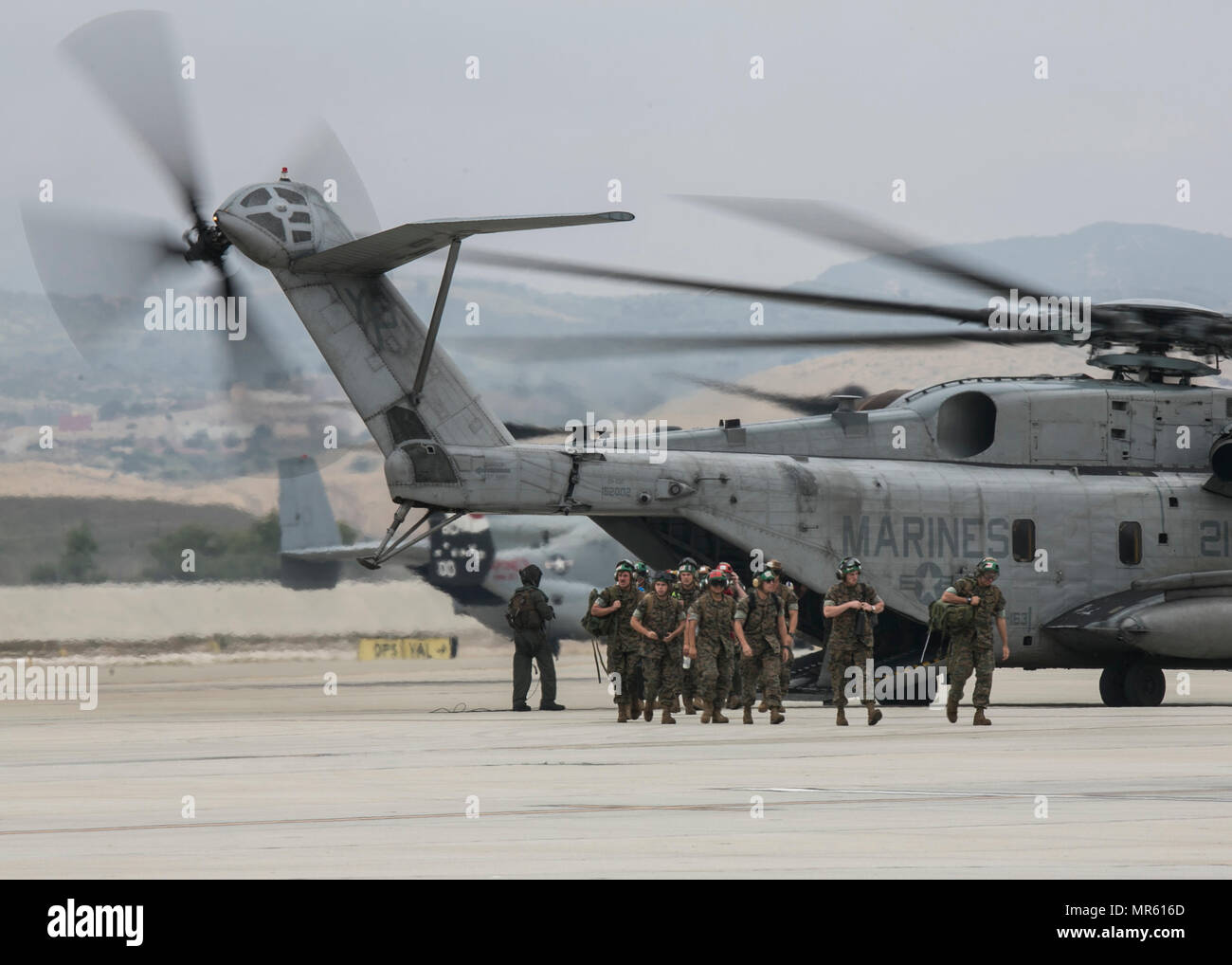 U.S. Marines with Light Attack Helicopter Squadron 369 (HMLA-369), 3d Marine Aircraft Wing, exits a CH-53E Super Stallion upon return from a deployment with the 11th Marine Expeditionary Unit, on Marine Corps Base Camp Pendleton, Calif., May 12, 2017. Friends and family members welcomed home Marines from the 11th MEU’s Command Element during a homecoming ceremony. (U.S. Marine Corps photo by Lance Cpl. Clare J. Shaffer/Released) Stock Photo