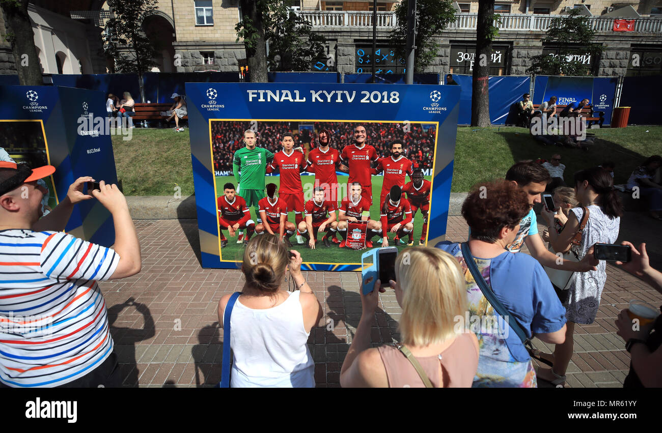 Fans pose with a cardboard cutout of the Liverpool team in Kiev where Liverpool will play Real