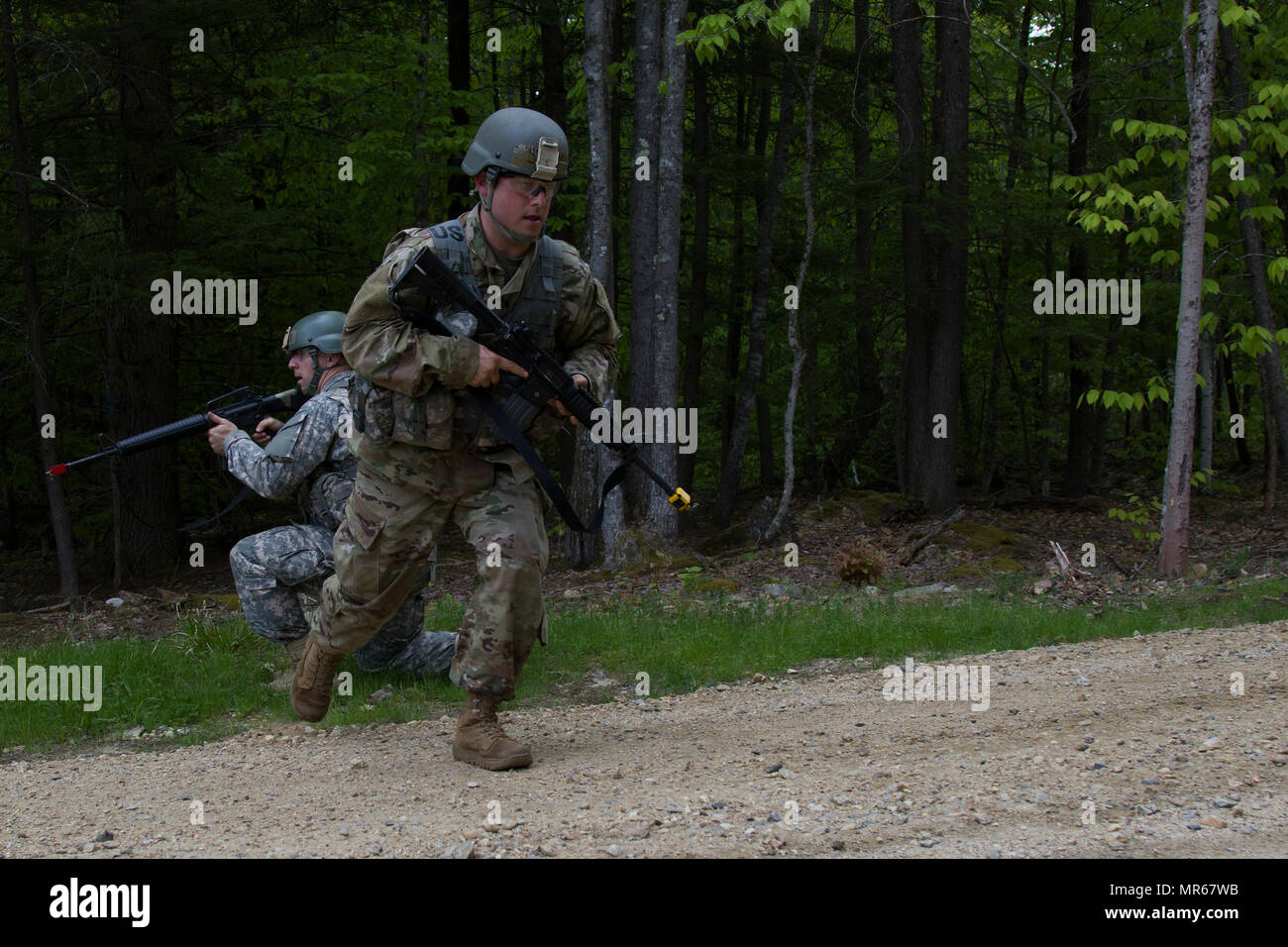 A U.S. Army officer candidate crosses a linear danger area (road) during a reconnaissance operations lane at New Hampshire National Guard Training Site in Center Strafford, Nh., May 19, 2017. Soldiers from Connecticut, Maine, Massachusetts, New Hampshire, New Jersey, New York, Rhode Island, and Vermont participated in the Officer Candidate School Field Leadership Exercise in preparation for graduation and commission. (U.S. Army National Guard photo by Spc. Avery Cunningham) Stock Photo