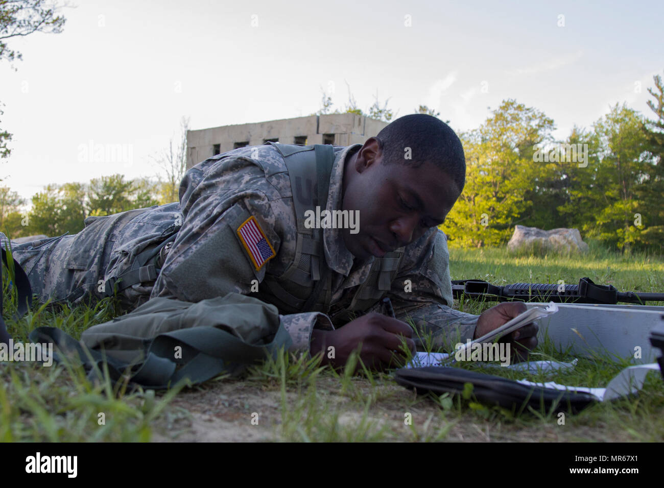 U.S. Army Officer Candidate Isaac Abotsi, with Hotel Company, 2nd Modular Training Battalion, 124th Regiment (Regional Training Institute), Vermont National Guard, plans for an enter and clear a building lane at New Hampshire National Guard Training Site in Center Strafford, Nh., May 19, 2017. Soldiers from Connecticut, Maine, Massachusetts, New Hampshire, New Jersey, New York, Rhode Island, and Vermont participated in the Officer Candidate School Field Leadership Exercise in preparation for graduation and commission. (U.S. Army National Guard photo by Spc. Avery Cunningham) Stock Photo