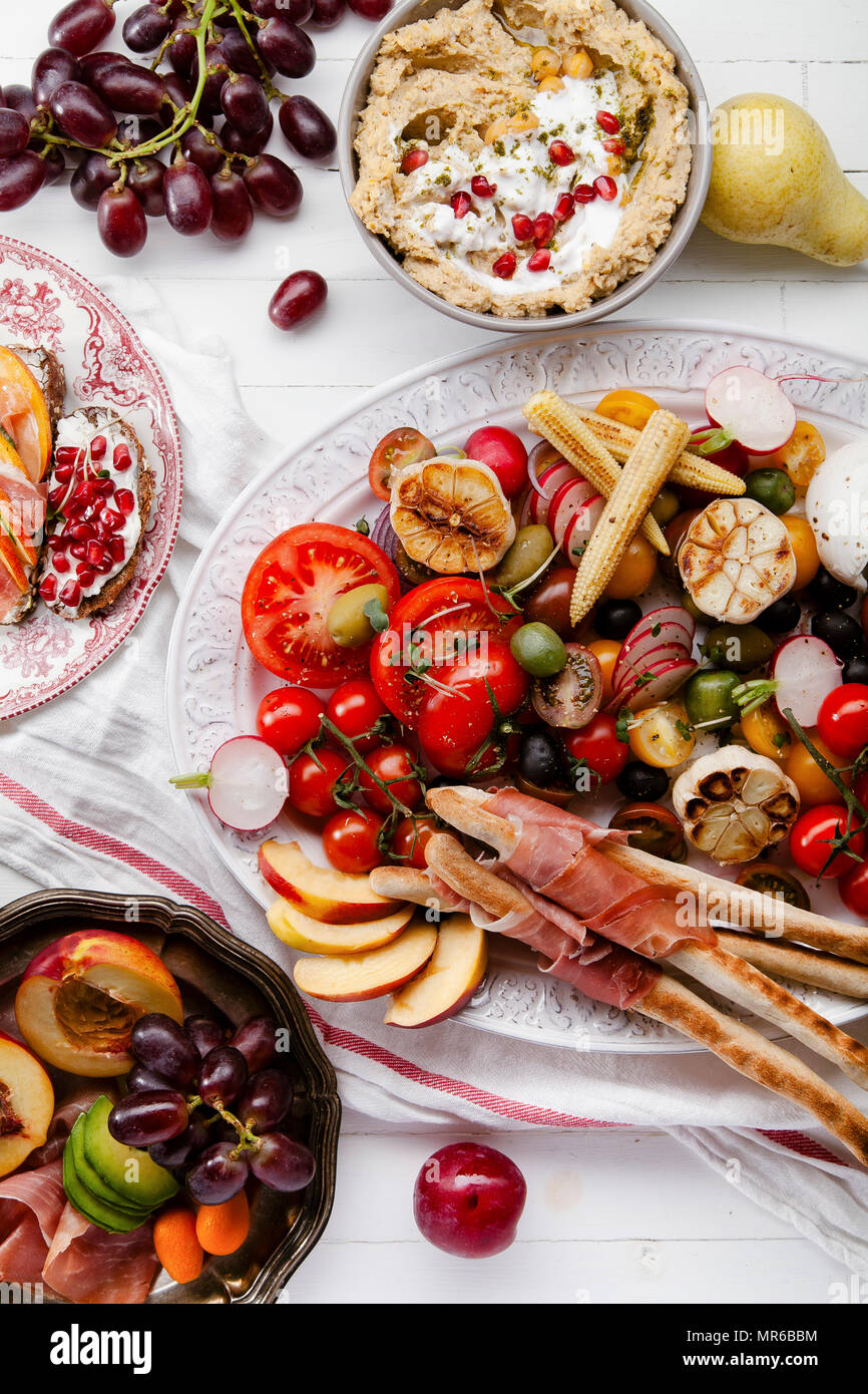 Variety of snacks prepared for picnic wine summer party with fresh