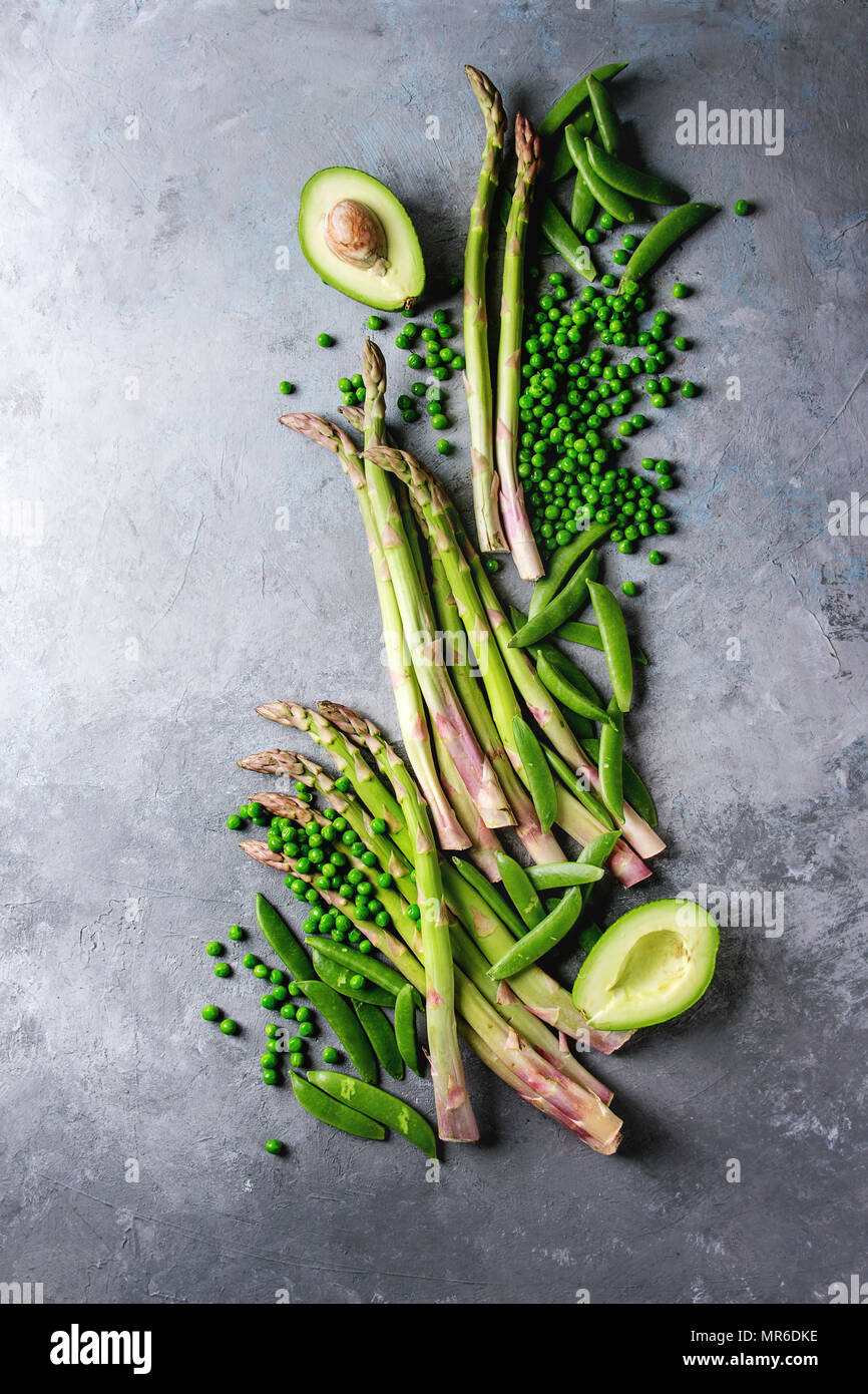Variety of raw uncooked organic young green vegetables asparagus, peas