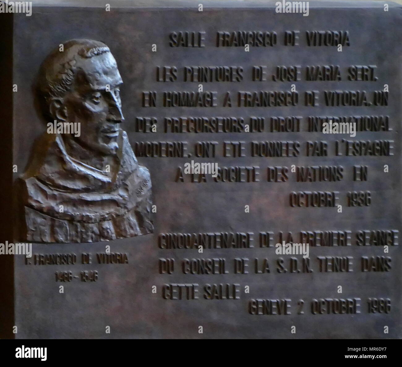 Francisco de Vitoria (1486-1546) plaque outside the Hall named after him at the UN, In Geneva. The council chamber, “Salle du Conseil,” was named after him. It was built for the League of Nations, and is the present meeting place of the Conference on Disarmament. Francisco de Vitoria was a Roman Catholic philosopher, theologian and jurist of Renaissance Spain. He is the founder of the tradition in philosophy known as the School of Salamanca, noted especially for his contributions to the theory of just war and international law Stock Photo