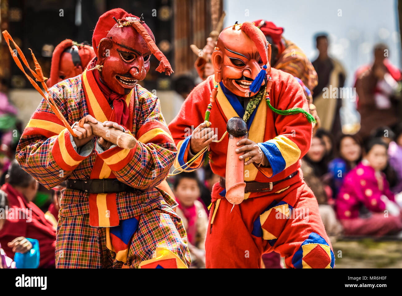 Fools, jesters with phallus symbol at the mask dance, religious Tsechu monastery festival, Gasa district Tshechu Festival, Gasa Stock Photo