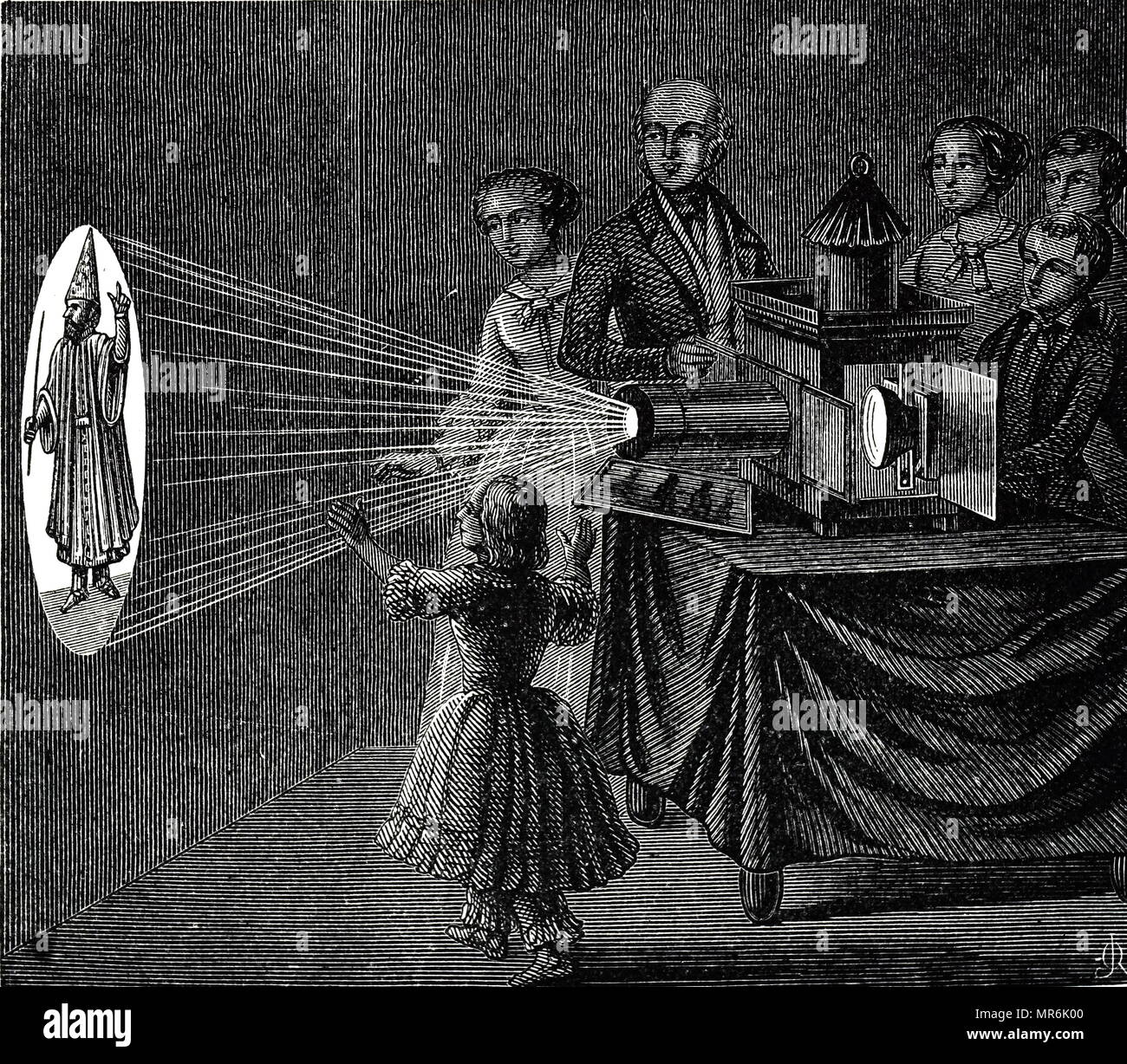 Engraving depicting a family enjoying a magic lantern show. The apparatus here differs little from that of Kircher in the 17th century, consisting of a metal box with lamp placed in focus of a concave mirror. Reflected light falls on a condensing lens which concentrates it on a glass slide, and the enlarged image is thrown on to a screen. Dated 19th century Stock Photo