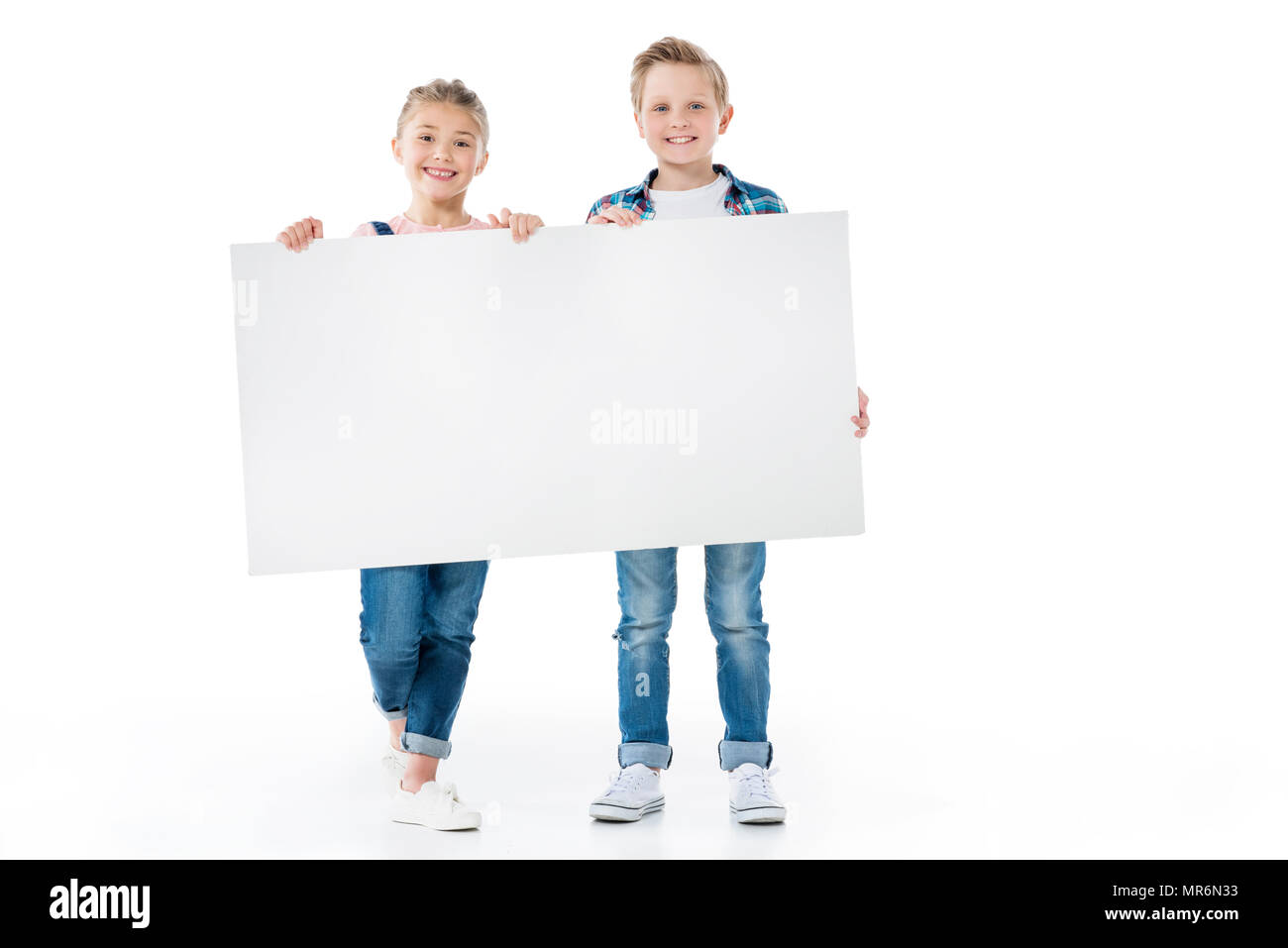 Cute little children holding blank banner and smiling at camera Stock ...