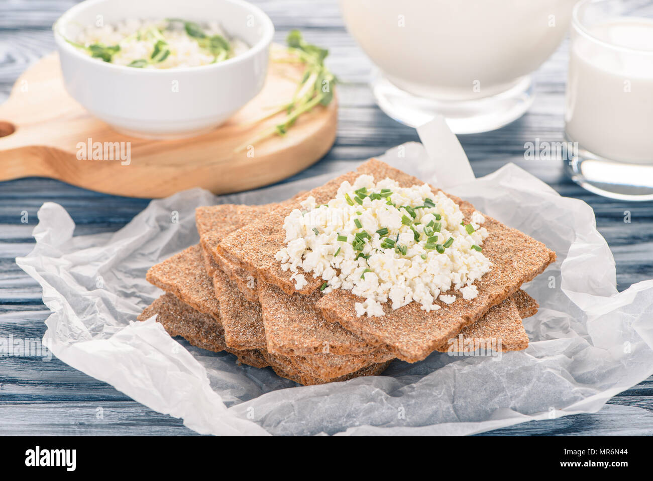 Close Up View Of Crispy Crackers With Topping Of Cottage Cheese On