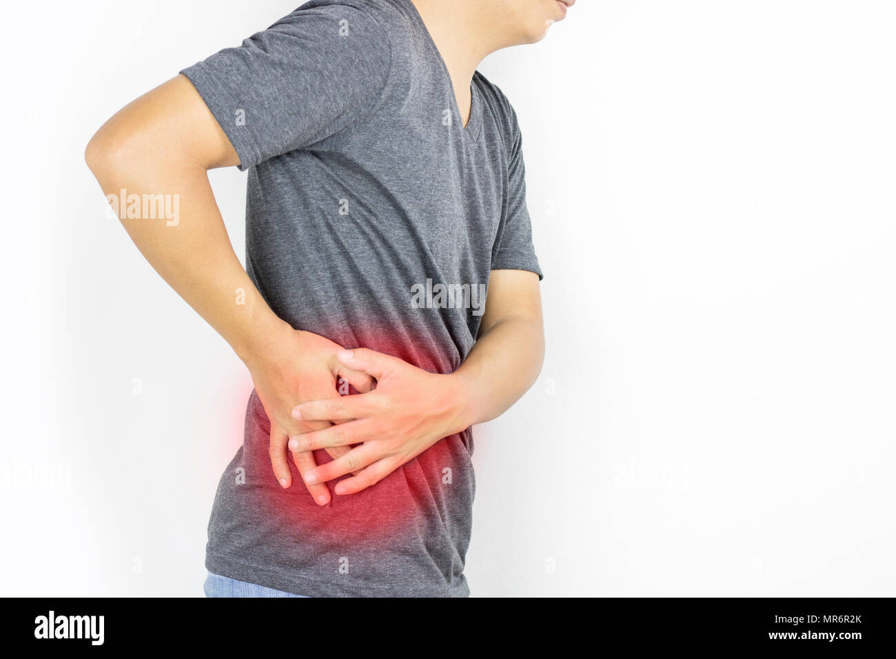 Man Guy Has Waist Pain In Gray Clothe On White Background Stock Photo man-guy-has-waist-pain-in-gray-clothe-on-white-background-stock-photo