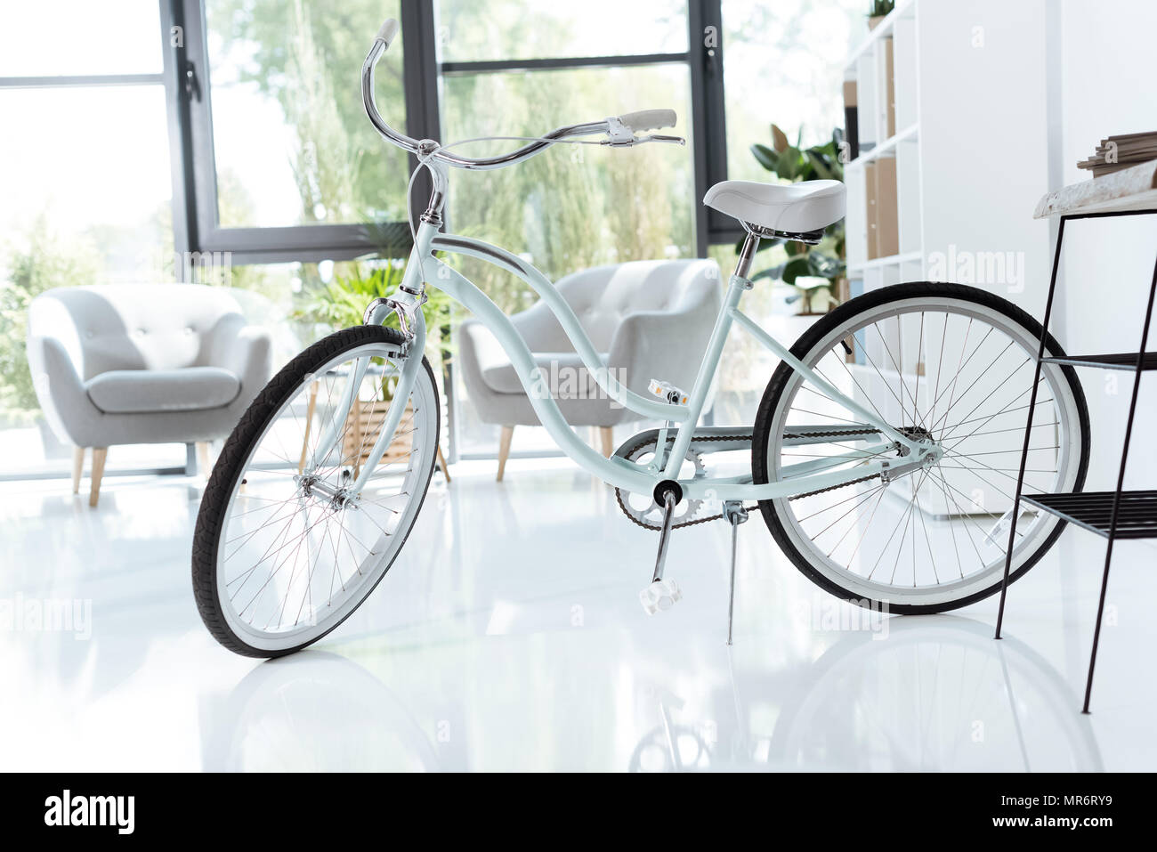 interior of empty creative office with bicycle and white chairs Stock