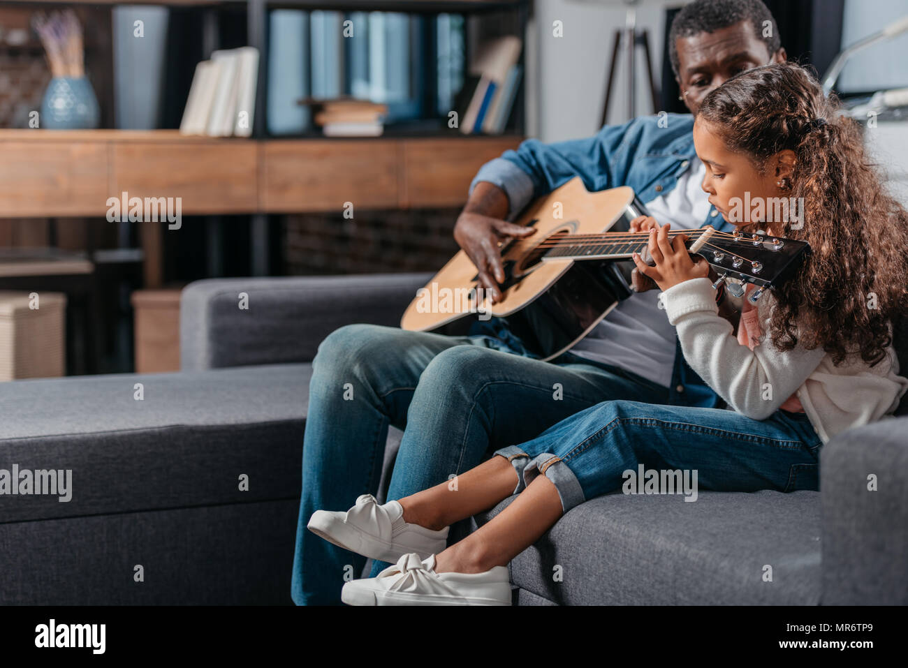 African american man playing guitar with his cute daughter Stock Photo ...