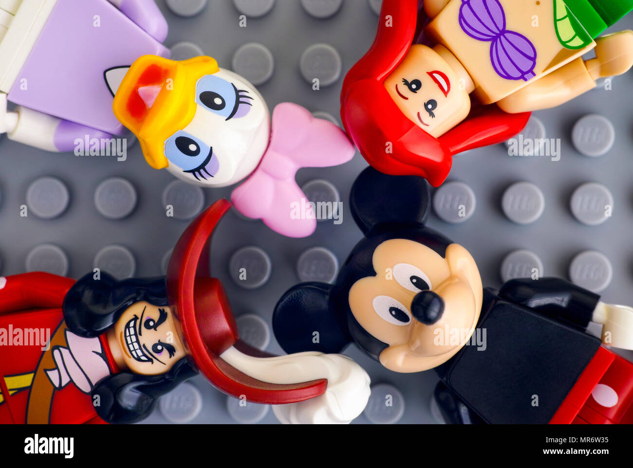 Tambov, Russian Federation - May 20, 2018 Four Lego Disney minifigures - Mickey Mouse, Daisy Duck, Ariel, Captain Hook, on gray background. Stock Photo