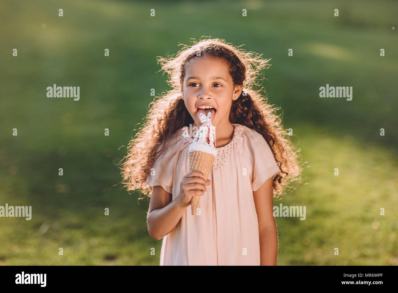 Girl licking ice cream hi-res stock photography and images - Alamy