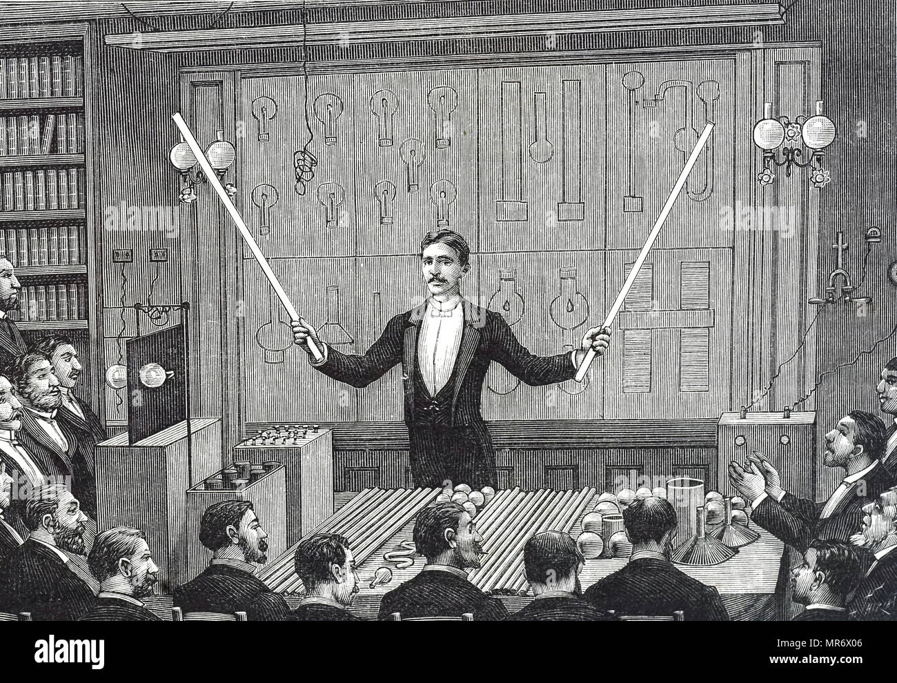 Engraving depicting Nikola Tesla addressing the Société Francaise de Physique and the International Society of Electricians. He is demonstrating electrode-less discharge with luminous discharge rods - the forerunner of fluorescent lighting. Nikola Tesla (1856-1943) a Serbian-American inventor, electrical engineer, mechanical engineer, physicist, and futurist. Dated 19th century Stock Photo