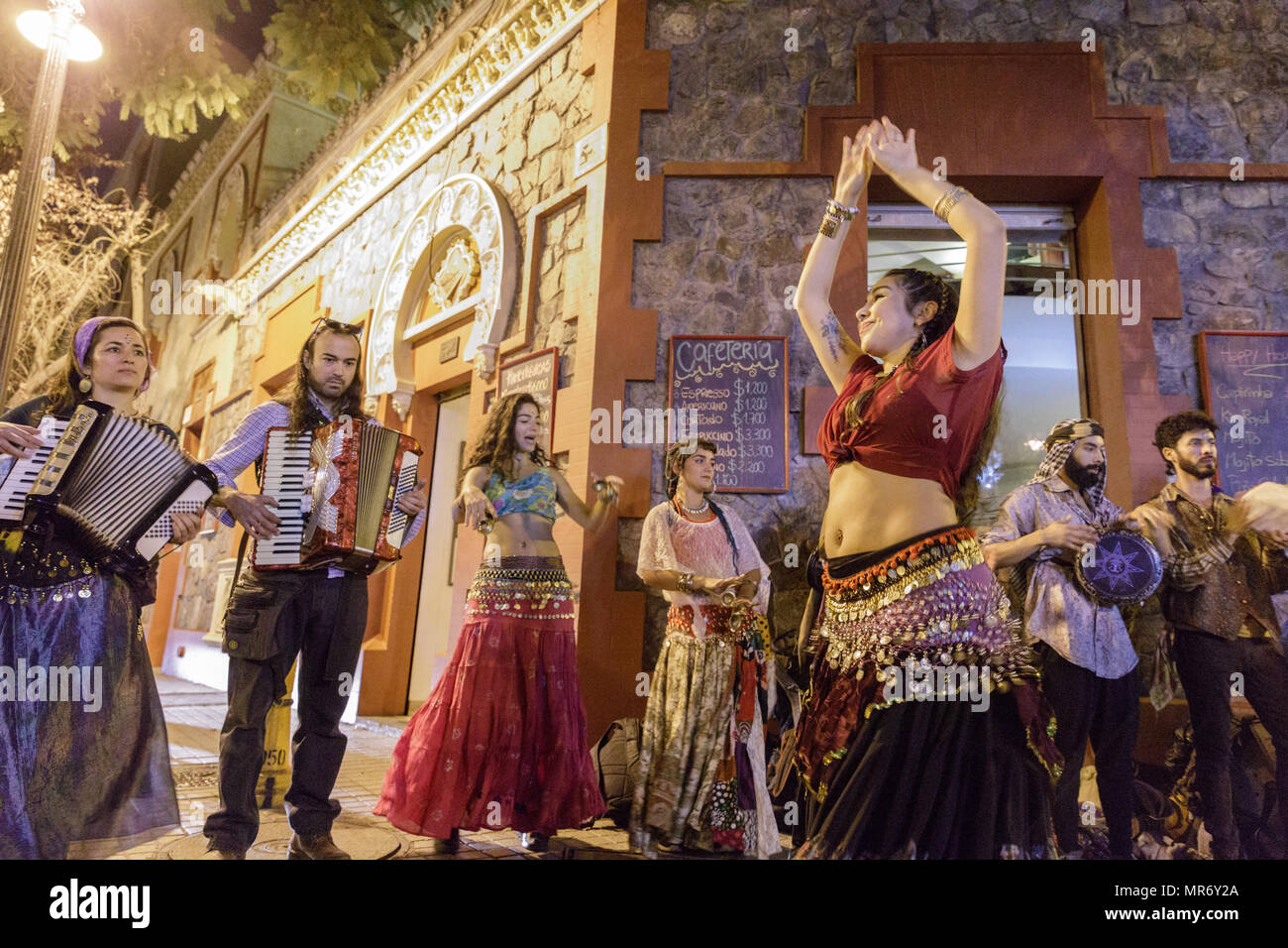 Lastarria, Santiago, Chile: A street band plays and dances to gypsy music. Stock Photo