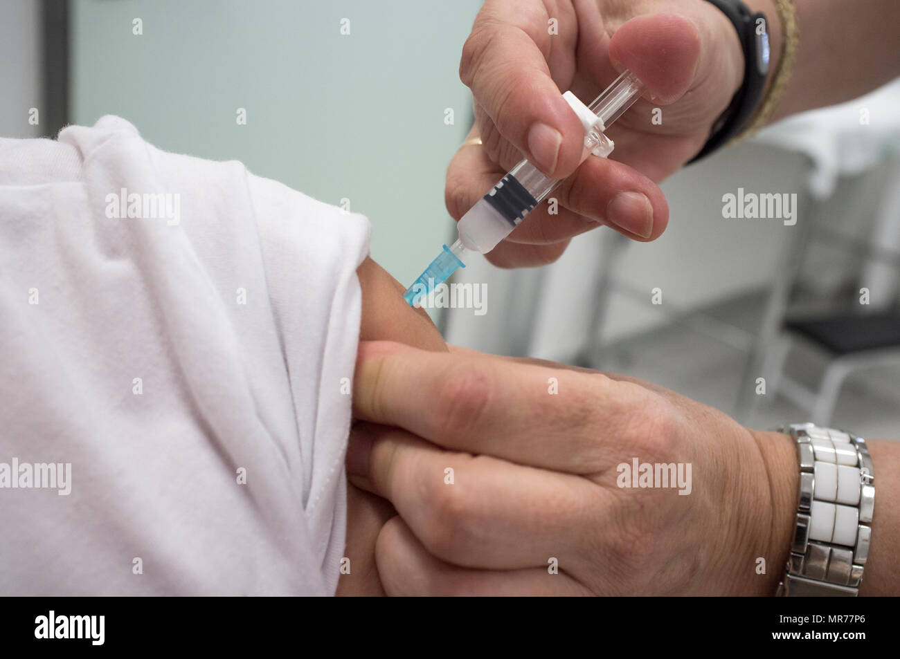 Nurse vaccinating little girl at Healthcare Center. Whooping cough, diphtheria and tetanus Stock Photo