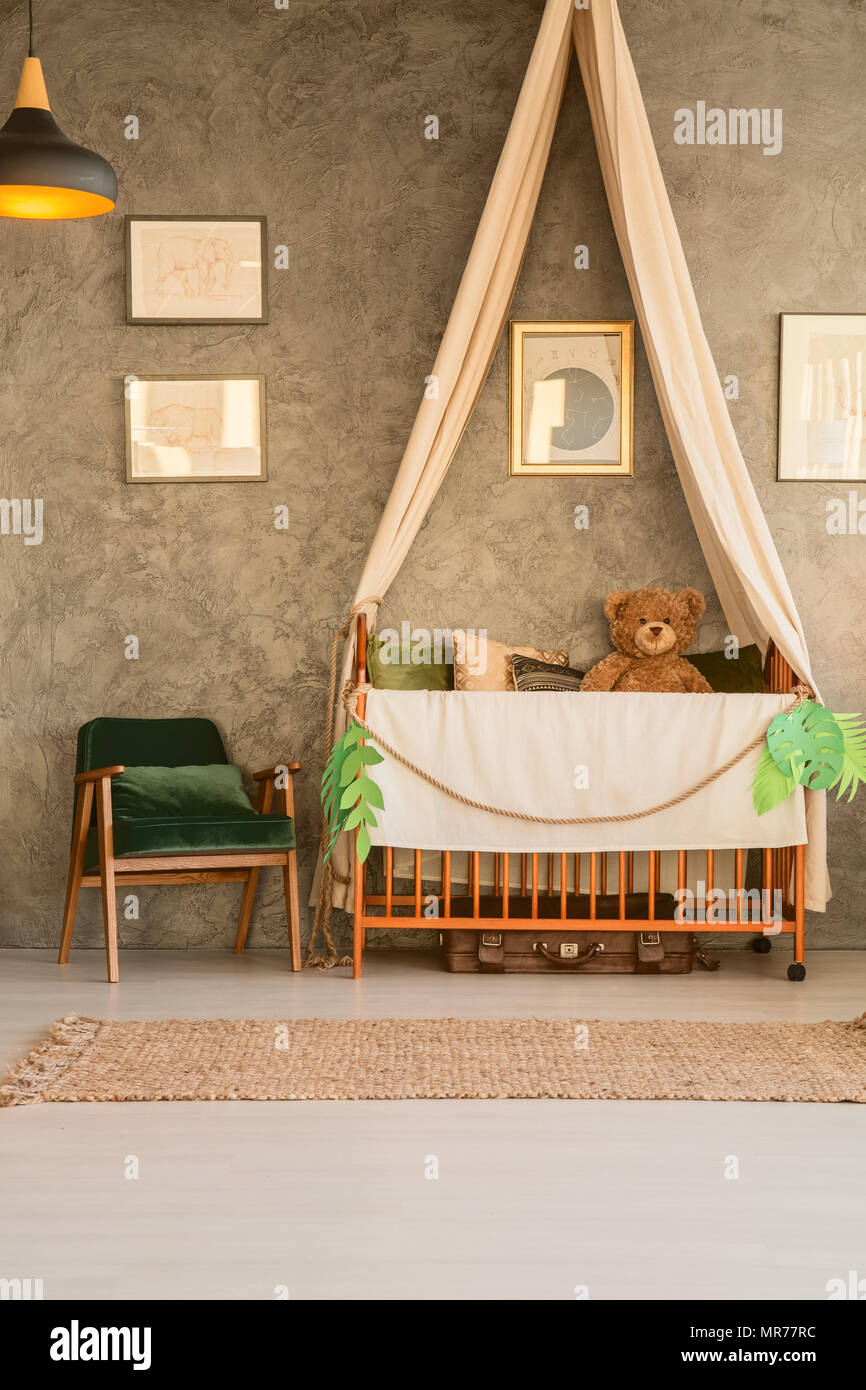 Baby cot with teddy bear in flat apartment Stock Photo Alamy