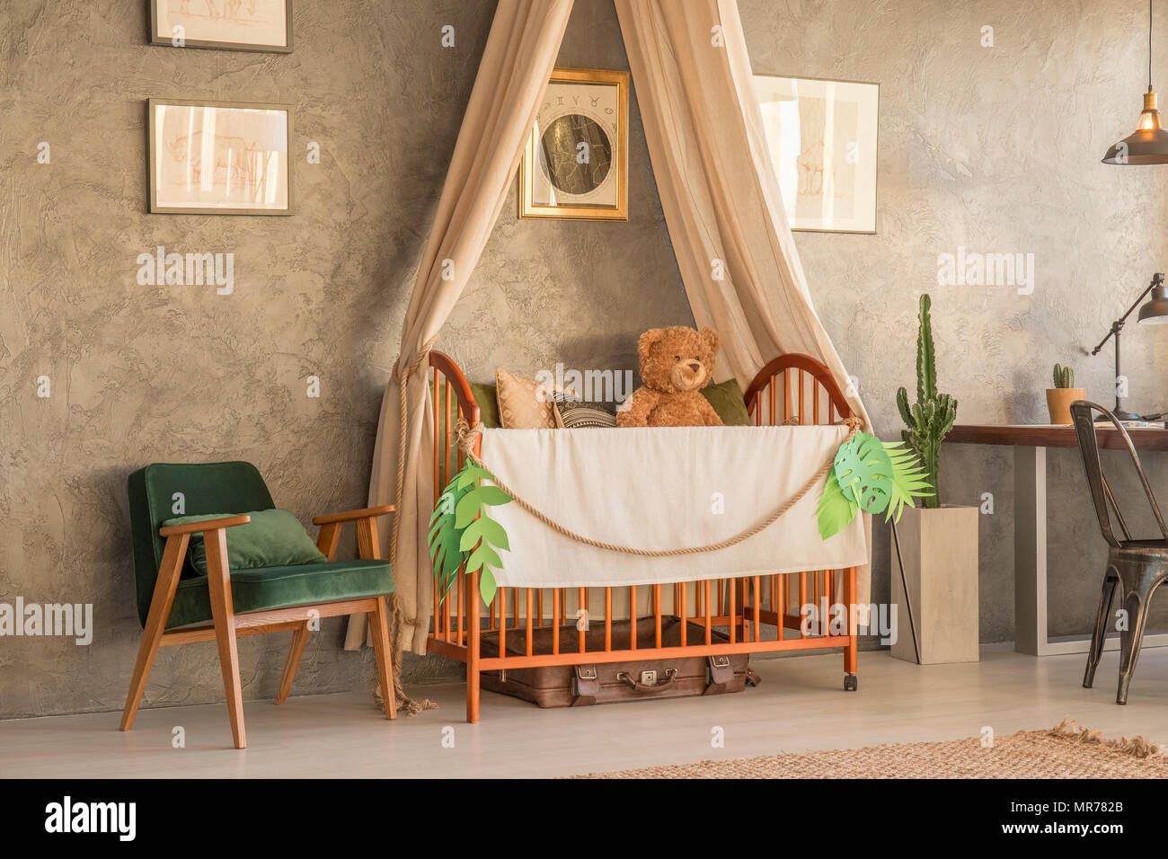 Spacious apartment area with crib and armchair Stock Photo Alamy