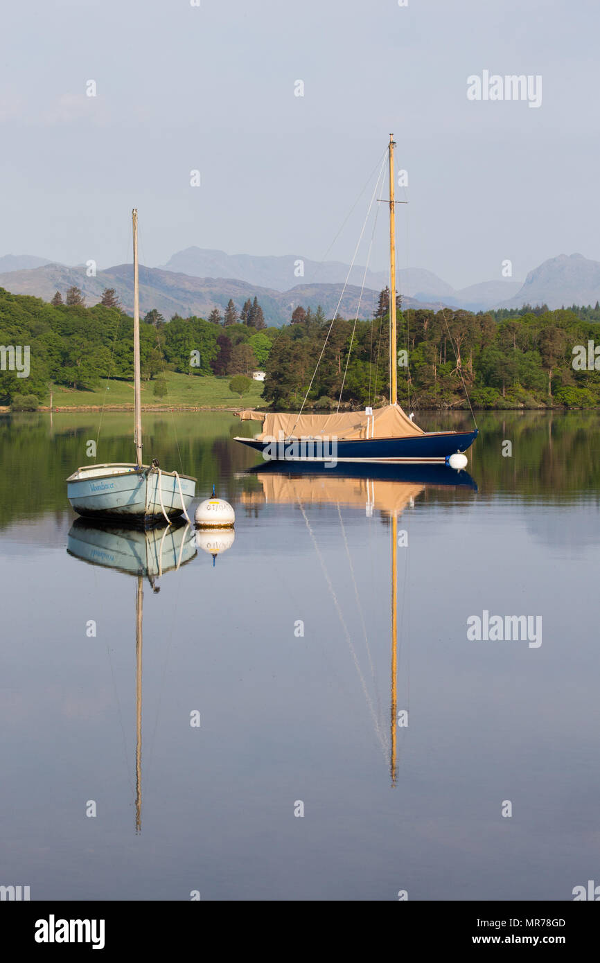 Two small sailing Dinghys moored on Lake Windermere, Cumbria, UK Stock Photo
