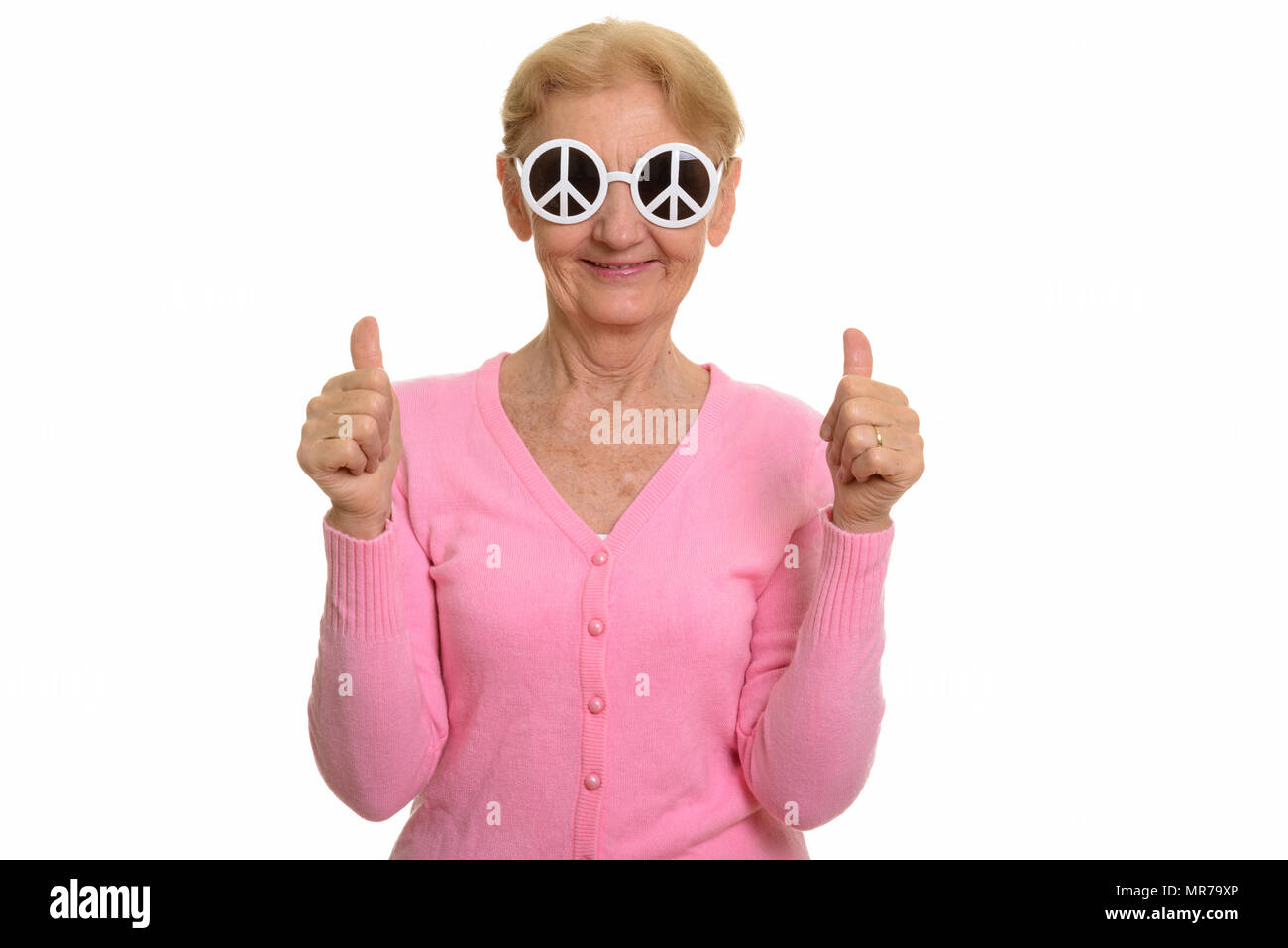 Happy senior woman smiling while wearing sunglasses with peace s Stock Photo