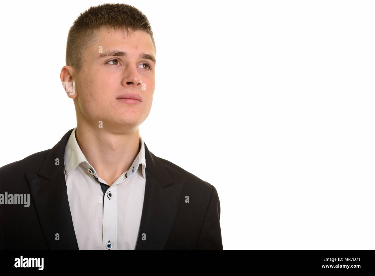 Studio shot of young businessman thinking Stock Photo - Alamy