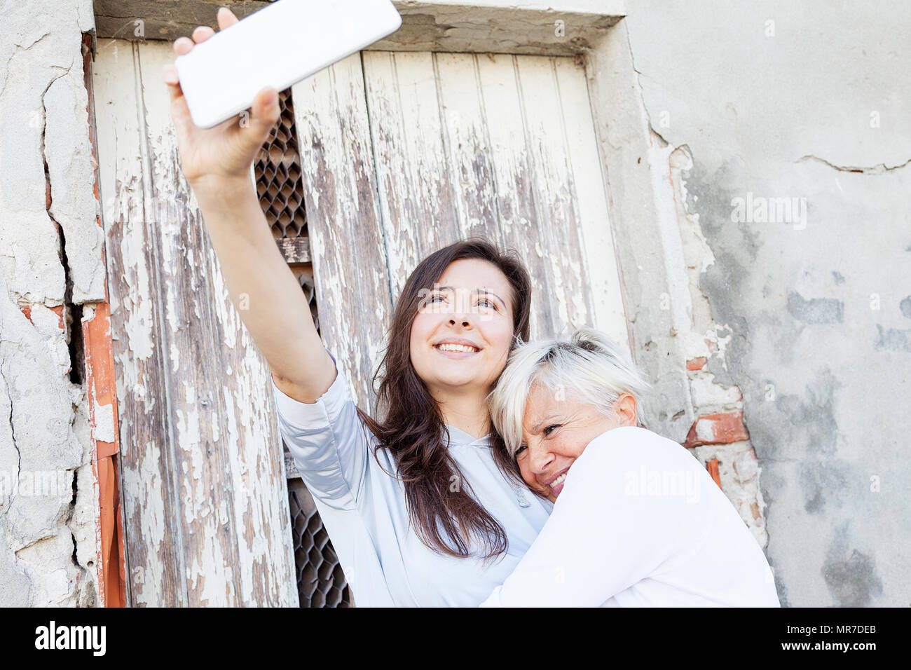 mother and adult daughter take a selfie outdoors Stock Photo