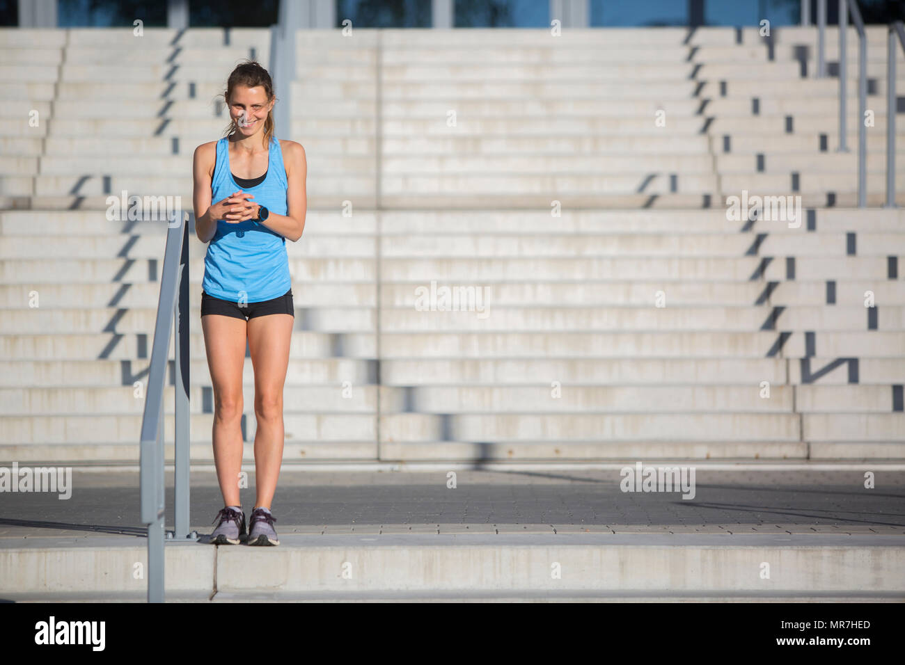 Cute Athlete woman warming up Stock Photo