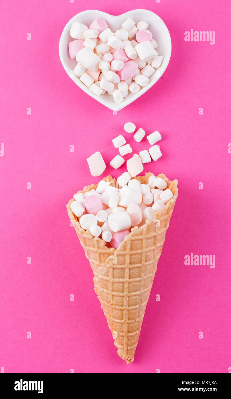 Marshmallows icecream and waffle cones on a pink background Stock