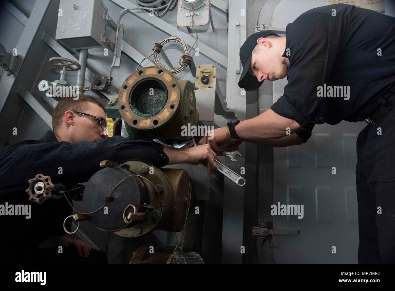 170518-N-KJ380-017  ATLANTIC OCEAN (May 18, 2017) Hull Maintenance Technician Fireman Brandon Bedwell, from Indianapolis, left, and Hull Maintenance Technician 3rd Class Joseph Becker, from Elizabethville, Penn., right, replace a collect, hold, and transfer valve on the portside boat davit aboard the aircraft carrier USS Dwight D. Eisenhower (CVN 69) (Ike). Ike is currently underway conducting engineering drills as part of the sustainment phase of the Optimized Fleet Response Plan (OFRP). (U.S. Navy photo by Seaman Neo Greene III) Stock Photo