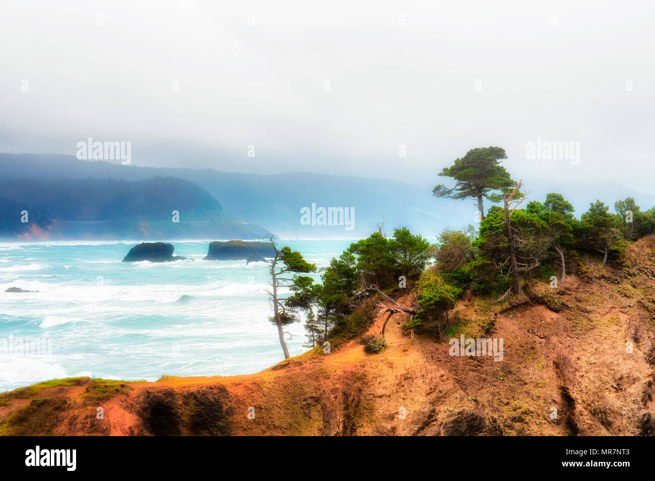 Stormy weather approaches the Oregon coastline at Pilot Rock in Port Orford, Oregon. Stock Photo