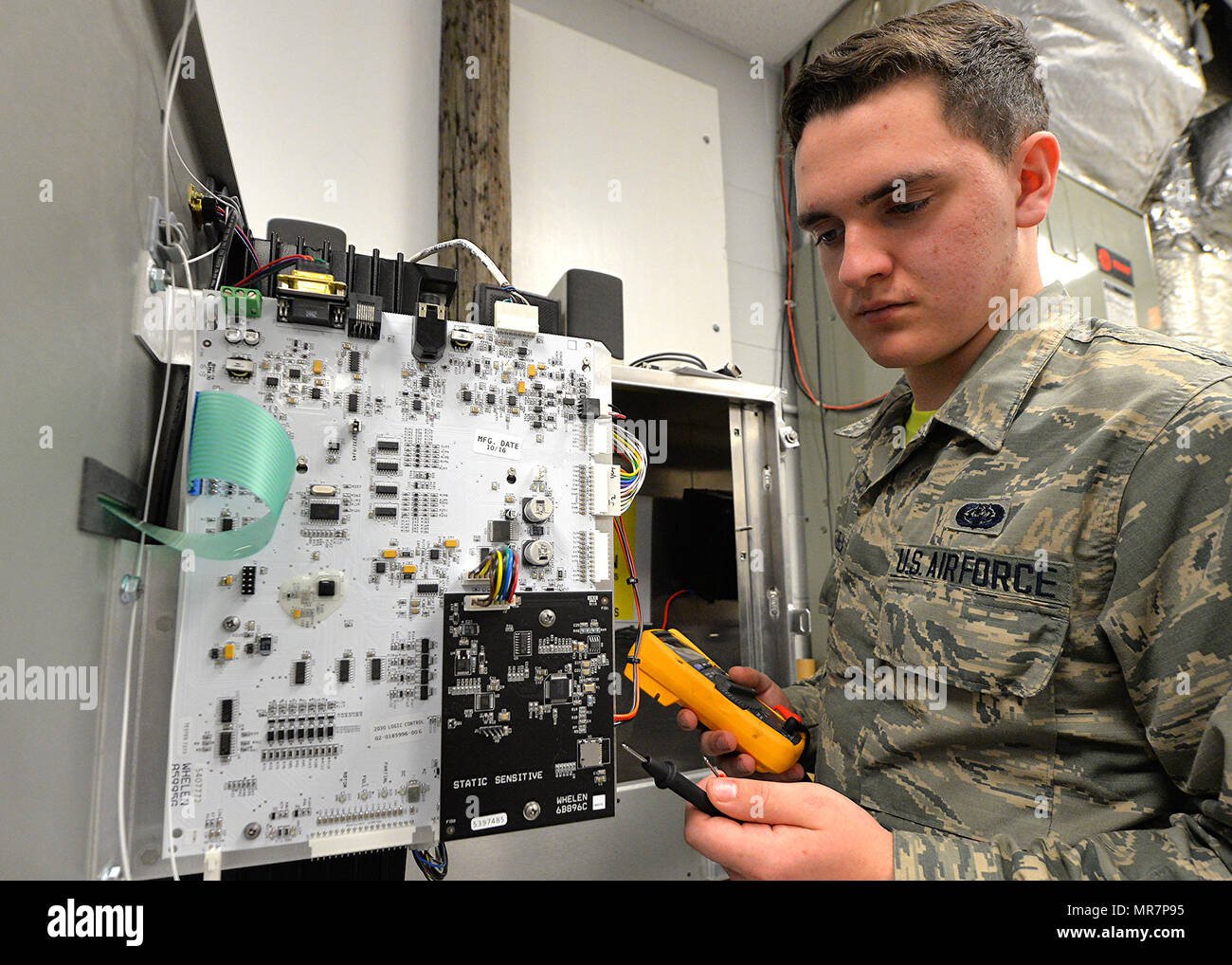 Airman Joseph Pascarella, 88th Communication Squadron radio frequency transmissions system technician, checks the board circuitry for the Wright-Patterson Air Force Base amplified speaker system, May 12, 2017. The amplified speaker system otherwise known as 'Giant Voice' is the base’s loudspeaker, which sounds everything from the imminent warning signals to the call of reveille/retreat along with the national anthem heard daily.  (U.S. Air Force Photo by Al Bright/Released) Stock Photo