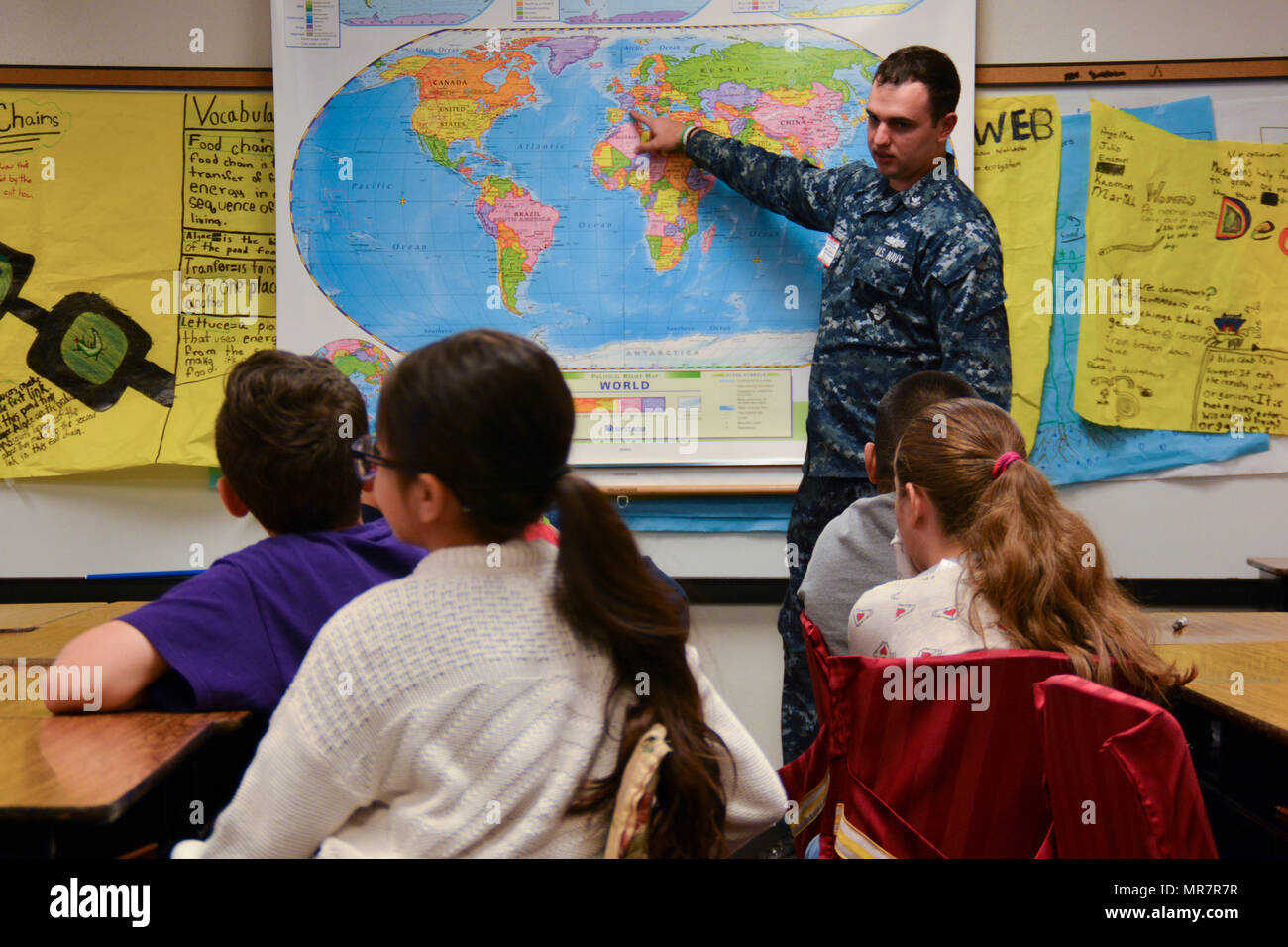 170519-N-IG780-048 IRVING, Texas (May 19, 2017) Machinist Mate 2nd Class Adam Al Sharif, a recruiter assigned to Navy Recruiting District (NRD) Dallas, shows everywhere he has traveled with the U.S. Navy to students at Thomas Haley Elementary School during Career Day. NRD Dallas encompasses 150,000 square miles that includes Northwest Texas and Oklahoma. (U.S. Navy photo by Mass Communication Specialist 2nd Class Shane A. Jackson/Released) Stock Photo
