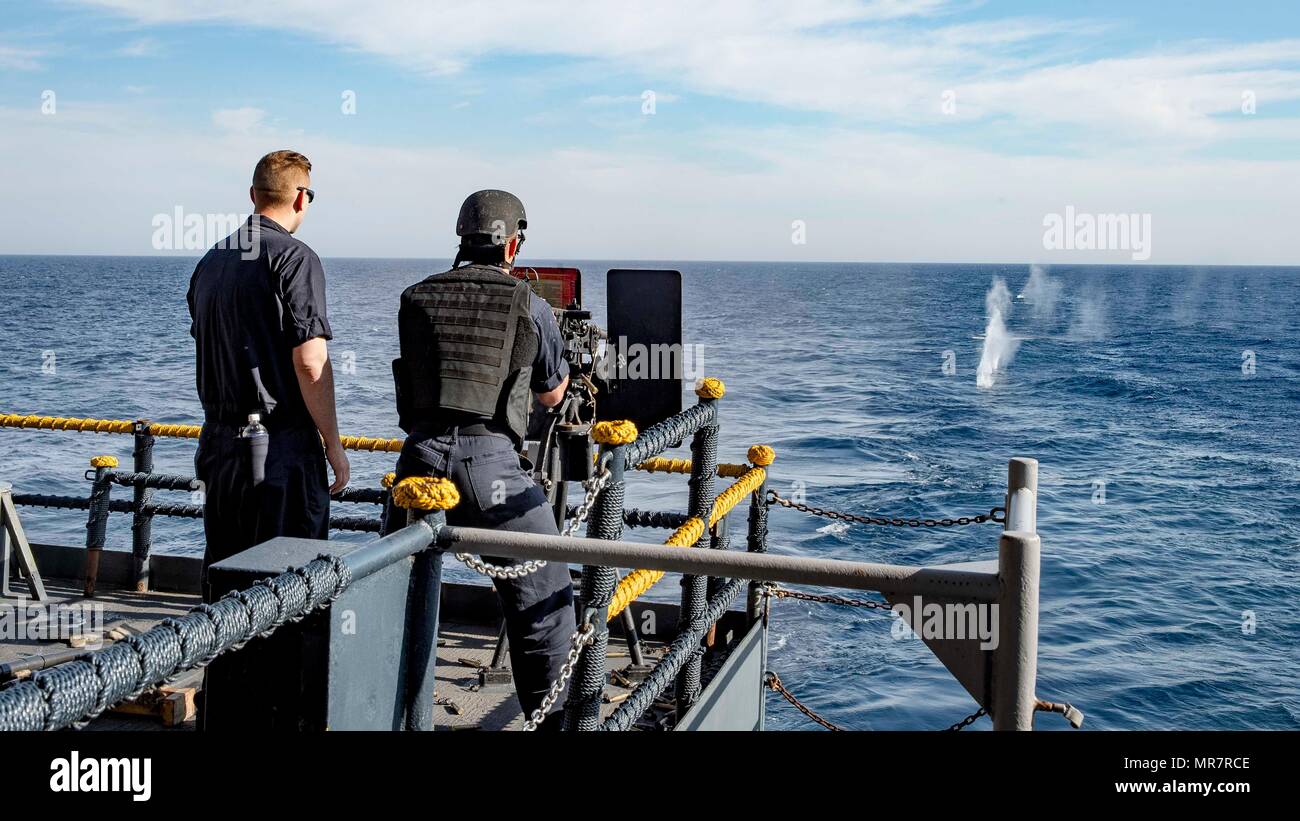 170518-N-QN175-011  ATLANTIC OCEAN (May 18, 2017) Gunner's Mate 3rd Class Taylor Sims, left, and Gunner's Mate Seaman Steven Centner, right, fire a .50-caliber machine gun during a live-fire exercise on the fantail of the aircraft carrier USS Dwight D. Eisenhower (CVN 69) (Ike).Ike is currently underway conducting engineering drills as part of the sustainment phase of the Optimized Fleet Response Plan (OFRP). (U.S. Navy photo by Mass Communication Specialist 3rd Class Dartez C. Williams) Stock Photo