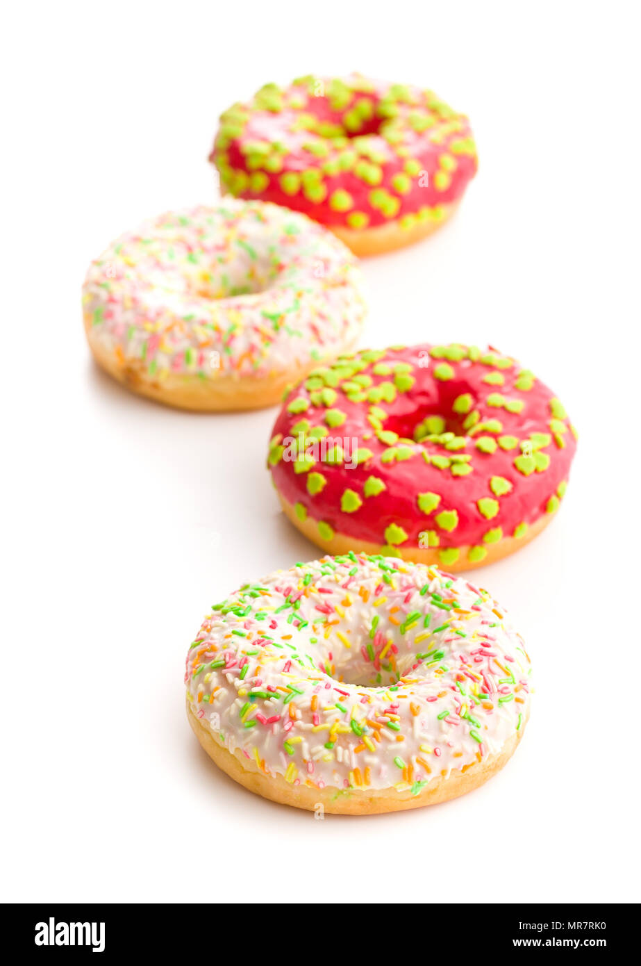 Sweet sprinkled donuts isolated on white background. Stock Photo