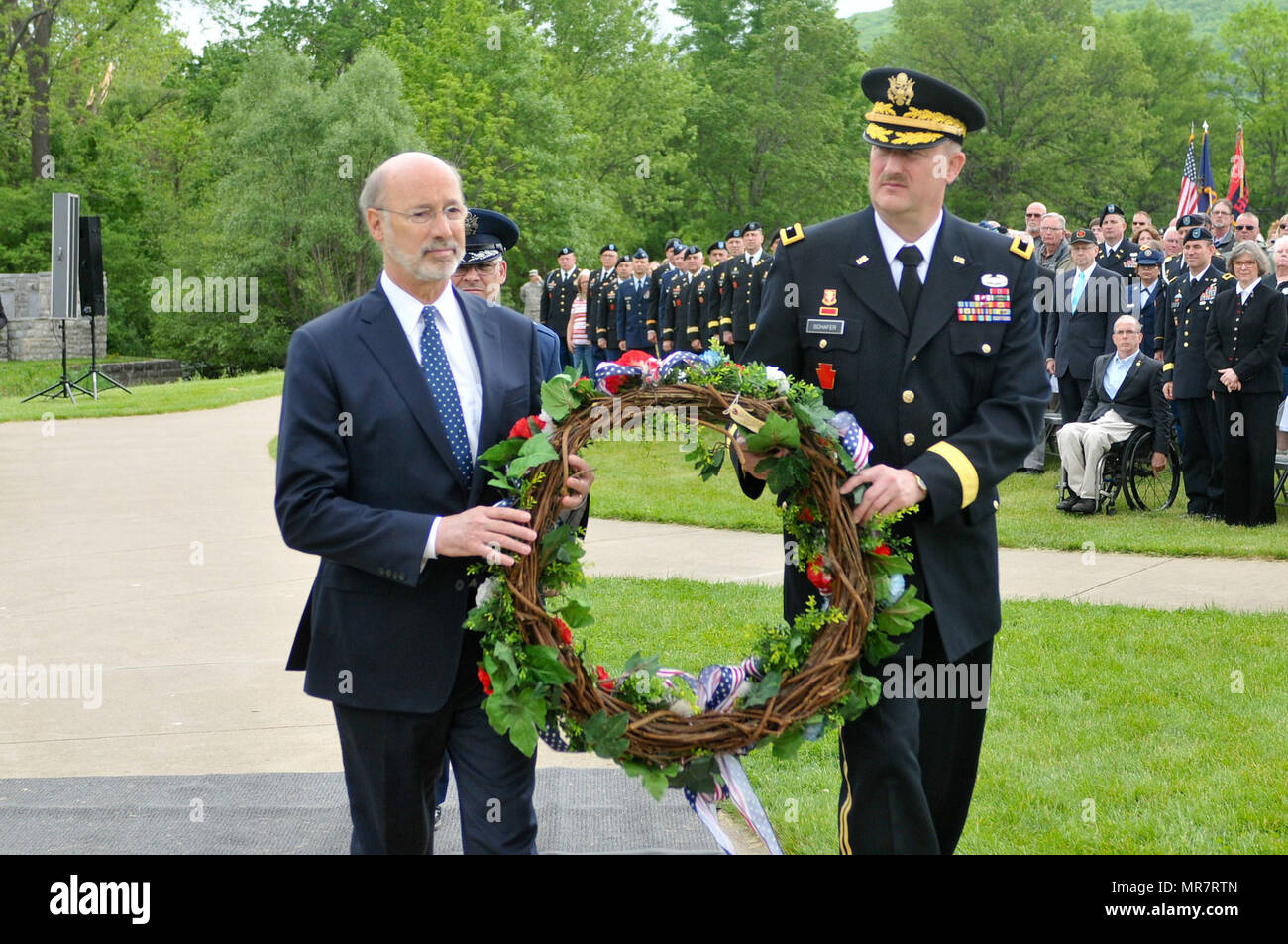 Pa. Gov. Tom Wolf and 28th Infantry Division Commander Brig. Gen. Andrew Schafer carry a wreath for placement at the division shrine in Boalsburg during the division's Annual Memorial Service May 21, 2017. Stock Photo