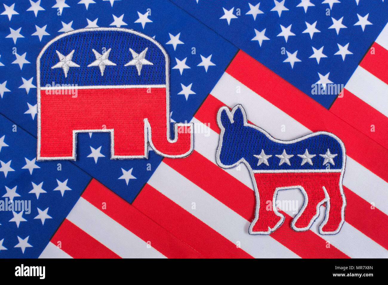 US Democrat Donkey logo & Republican elephant logo on Stars and Stripes. For 2024 US General election, Midterms, 2024 Presidential election race USA Stock Photo