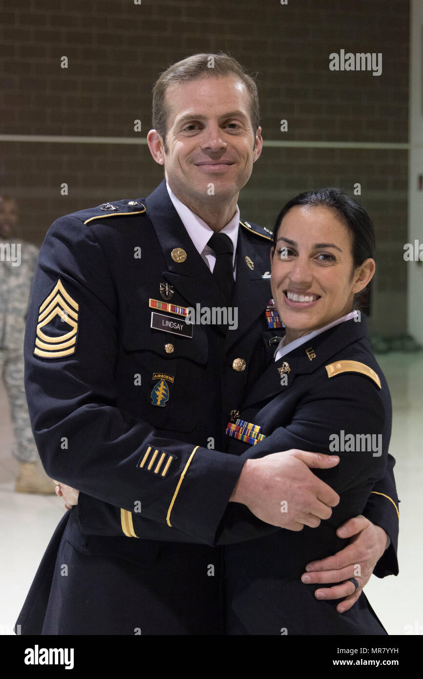 2nd Lt. Marisa Lindsay poses with her husband, Master Sgt. Michael Lindsay, Special Forces Advisor with the 1-196th Infantry Regiment, after a commissioning ceremony at the National Guard armory on Joint Base Elmendorf-Richardson, Alaska, May 21, 2017. Lindsay earned the distinction of Honor Graduate and was recognized with the High Physical Fitness Award from the Officer Candidate School at the Alabama Military Academy.    (U.S. Army National Guard photo by Spc. Michael Risinger) Stock Photo